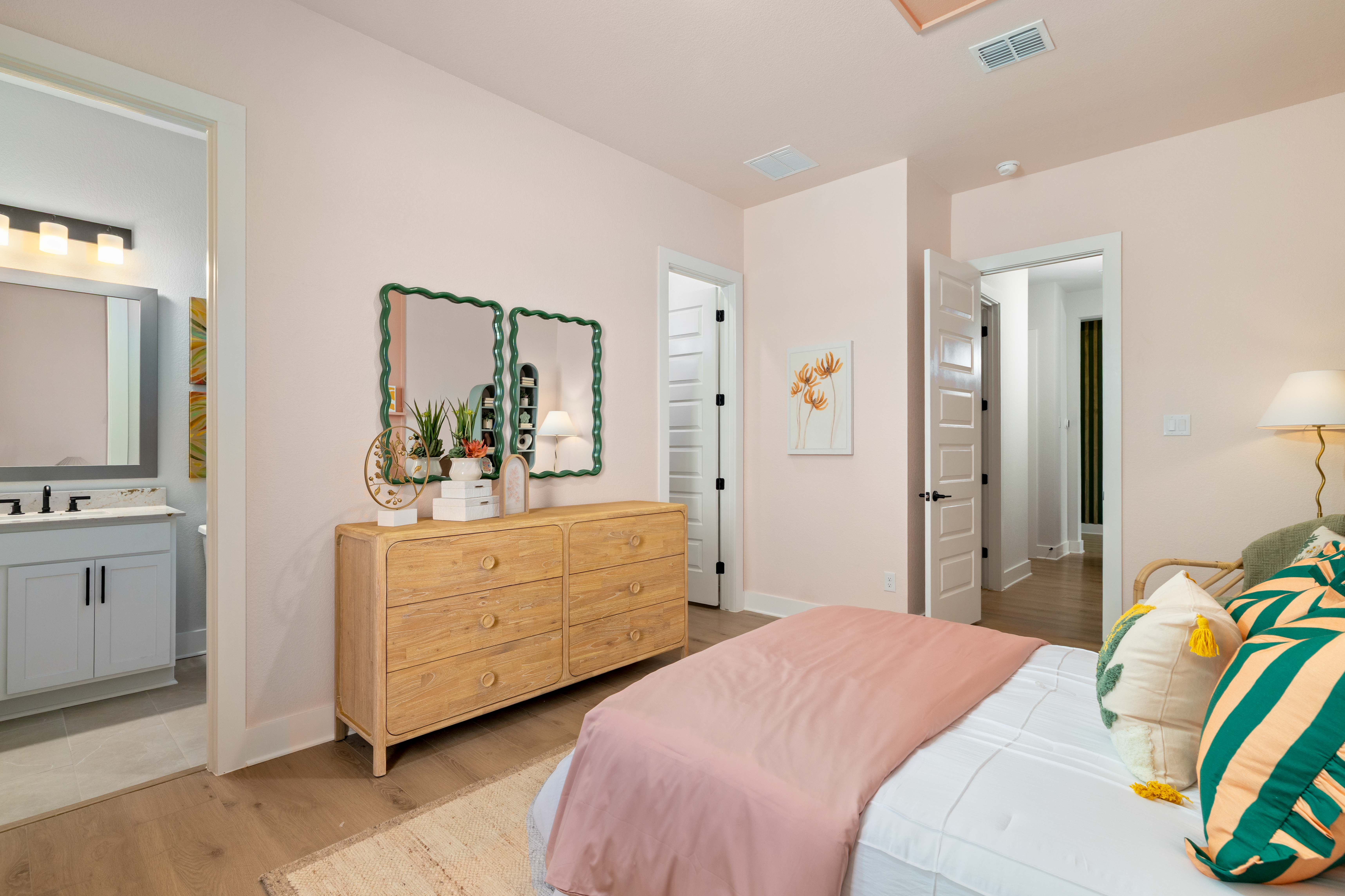 A bedroom with a bed and a dresser.