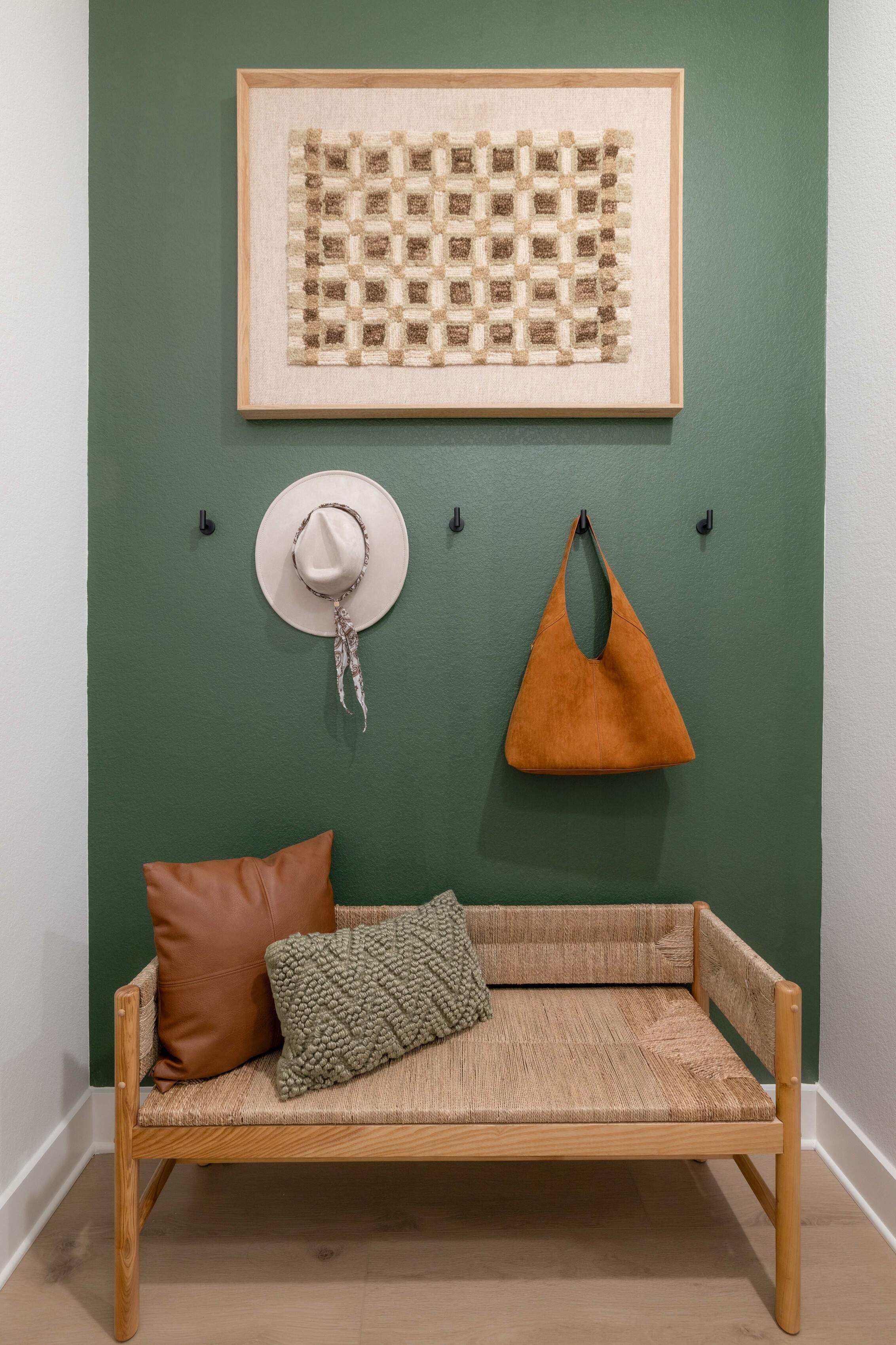 A couch with a lamp on the wall.