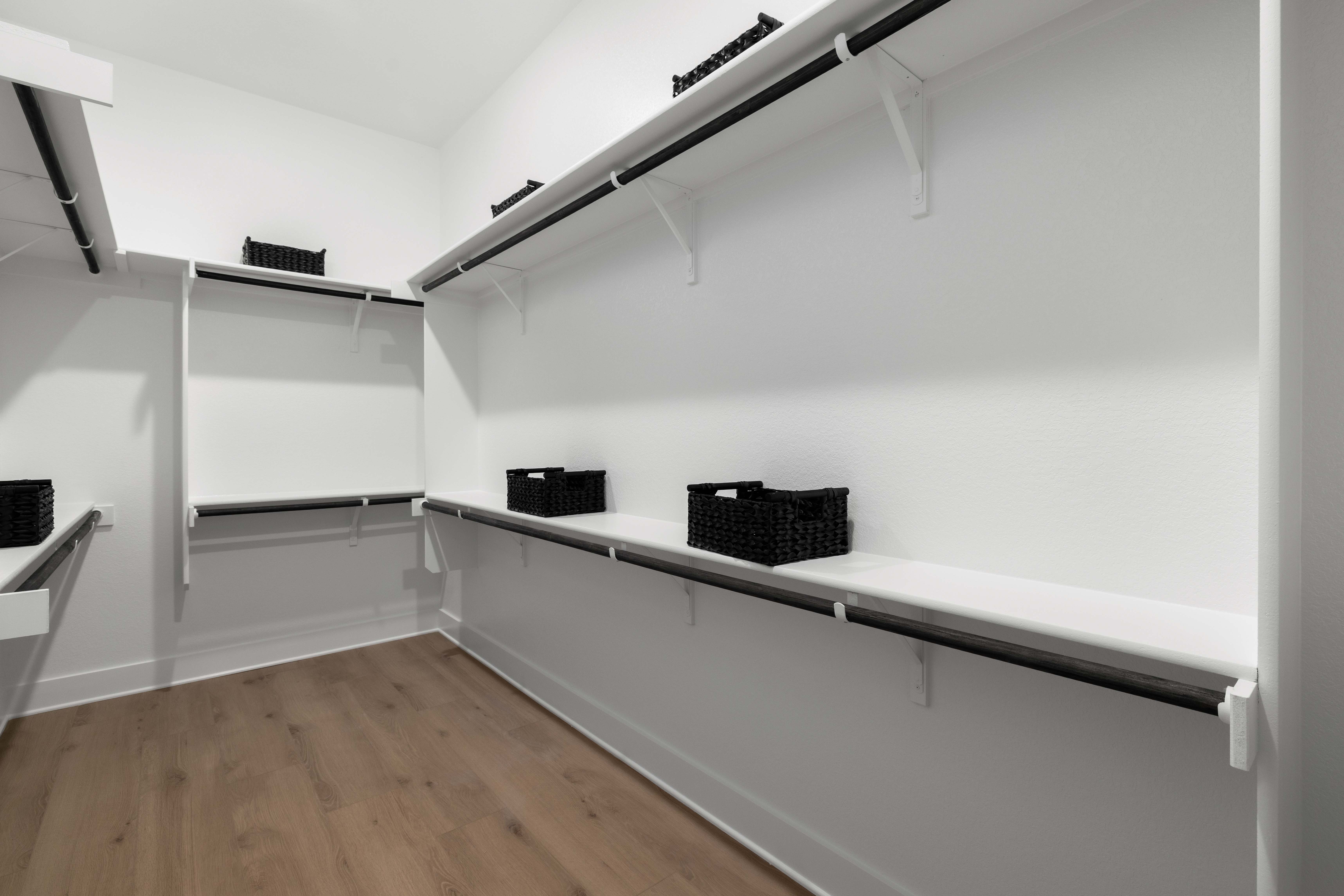 A white room with a shelf and a basket.