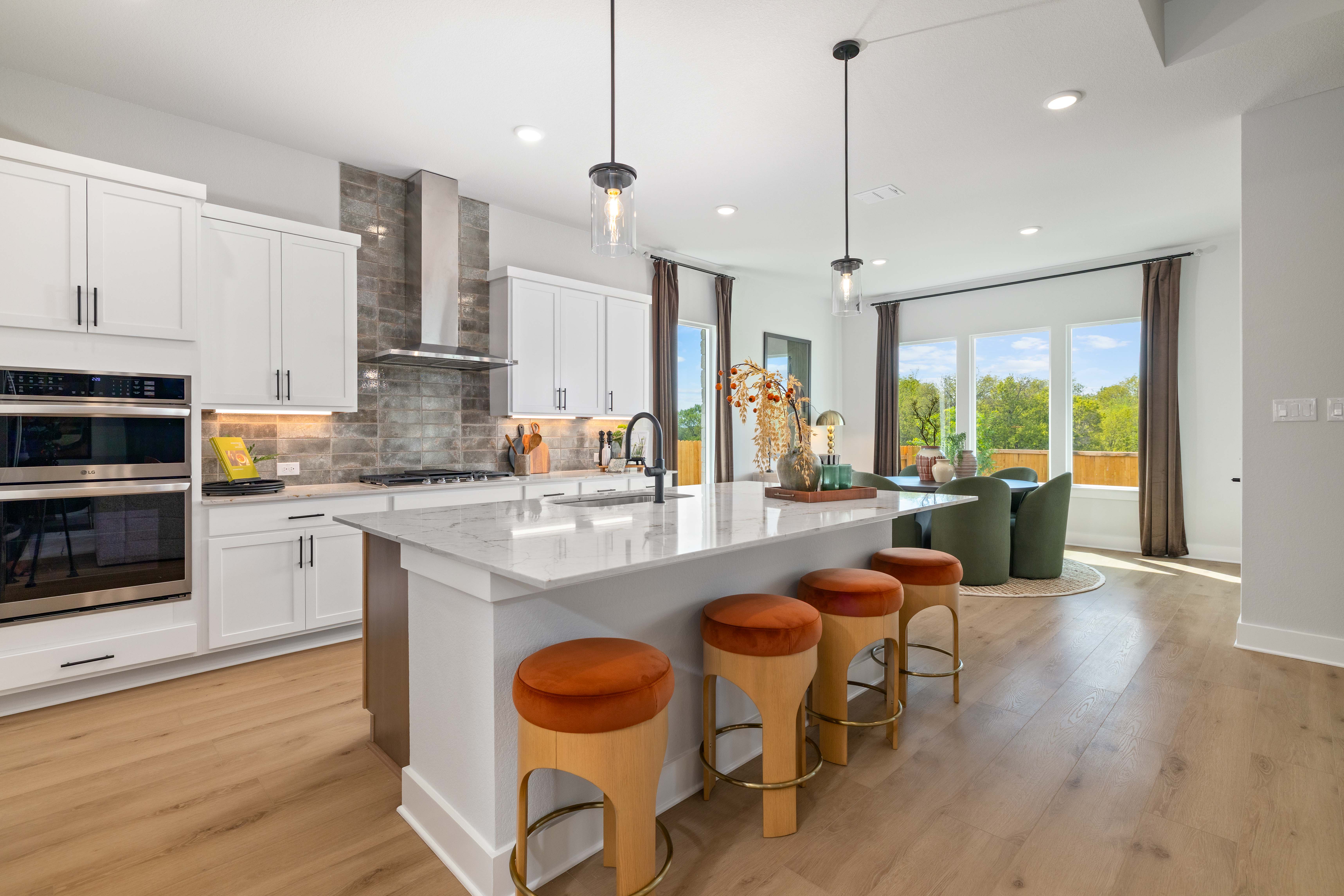 A kitchen with stools and a table.