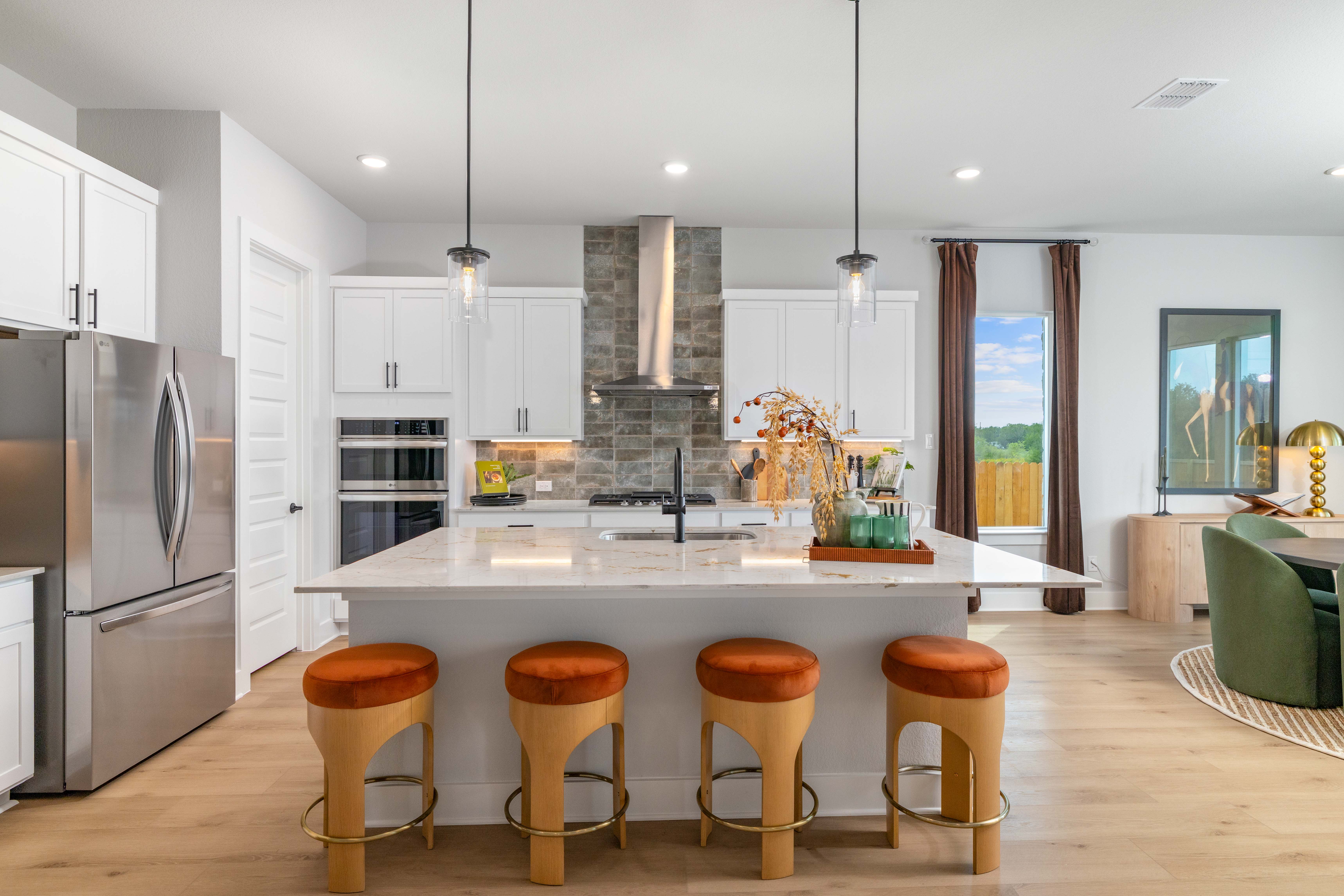 A kitchen with stools and a table.