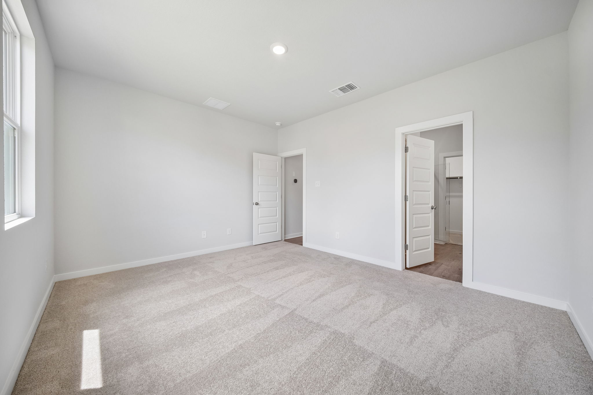 A hallway with white walls.
