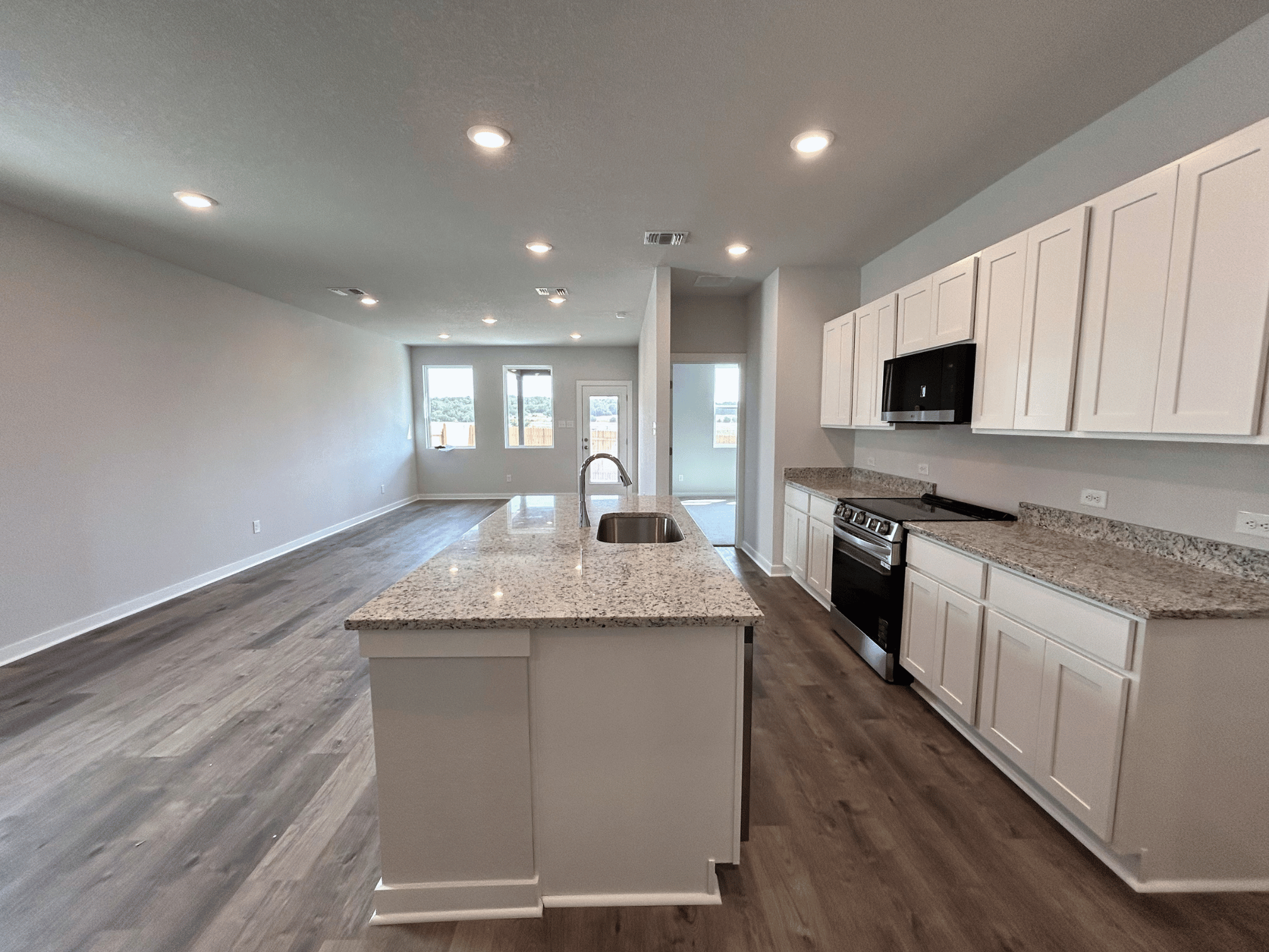 A kitchen with white cabinets.