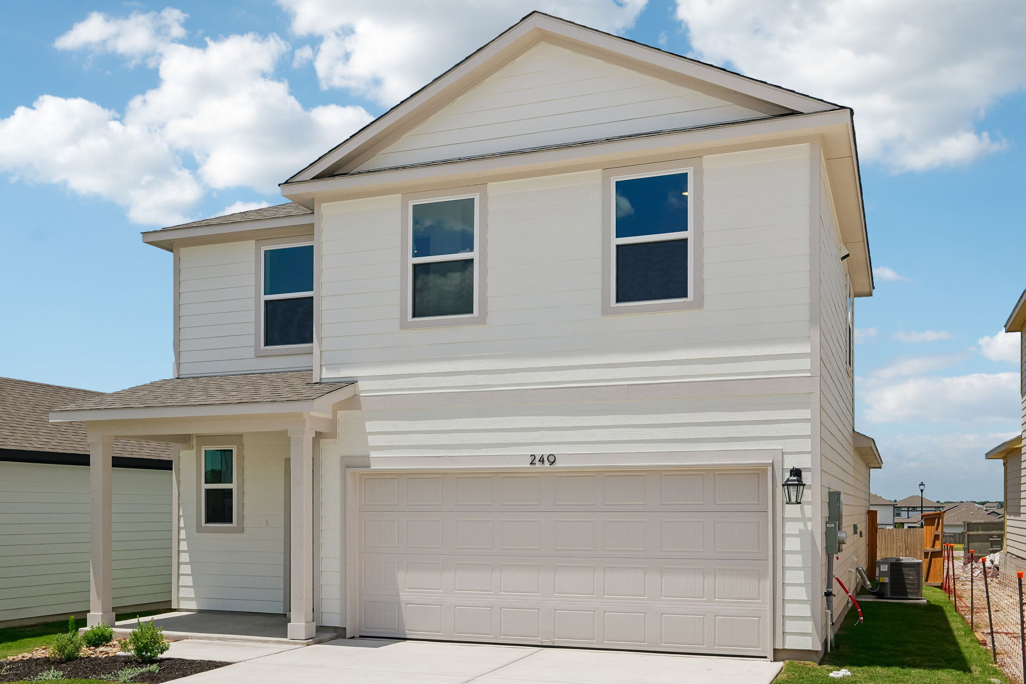 A white house with a garage.