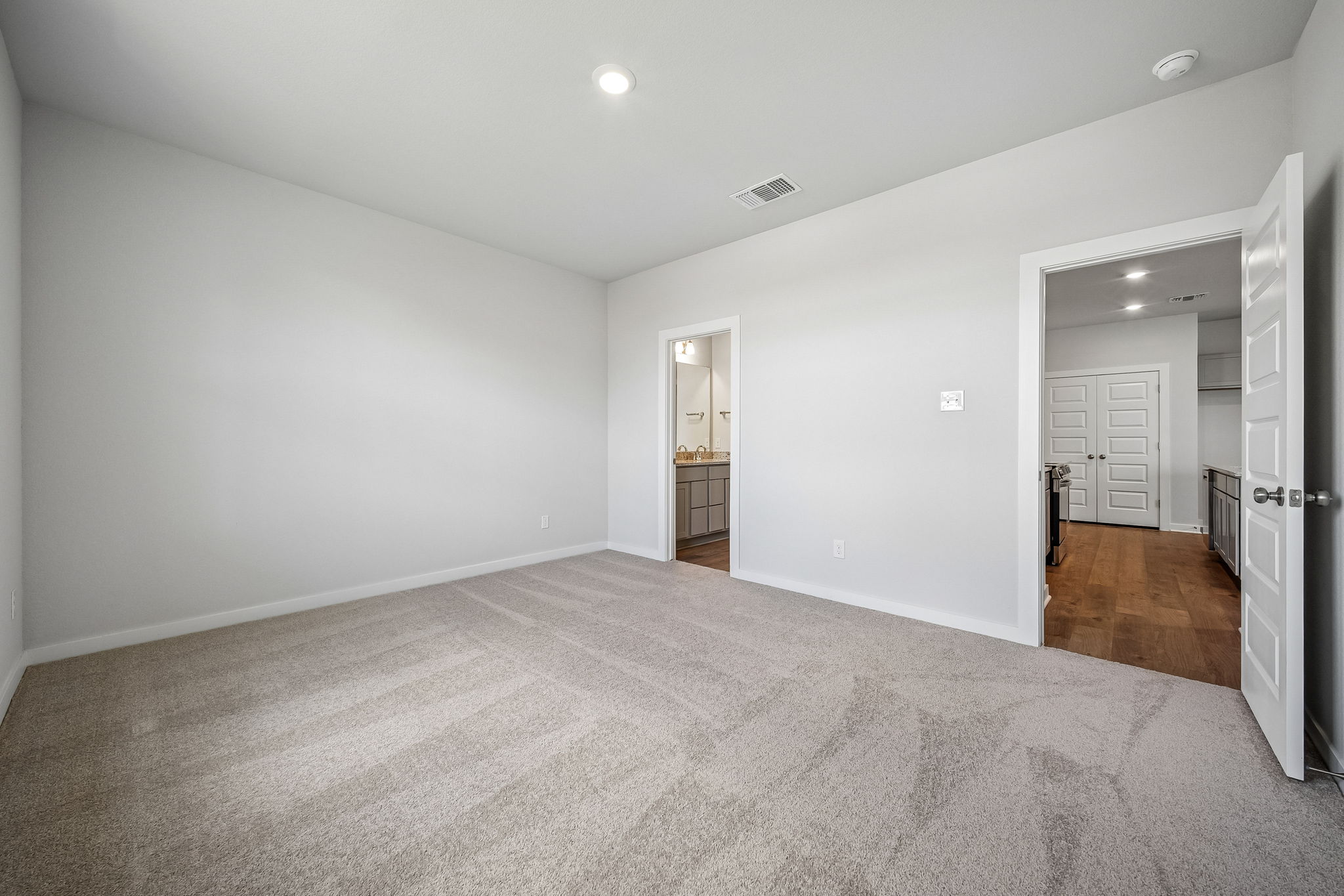 A hallway with white walls.