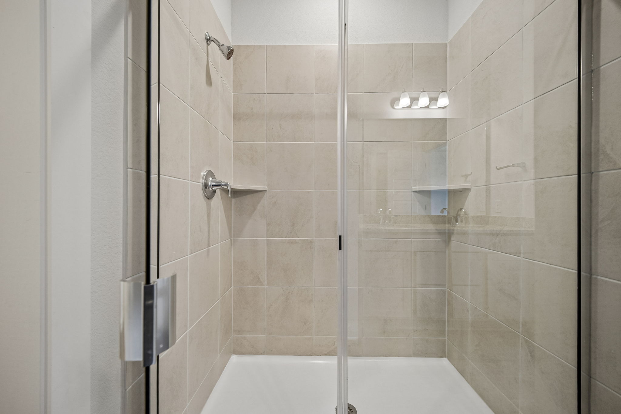 A shower with a glass door.