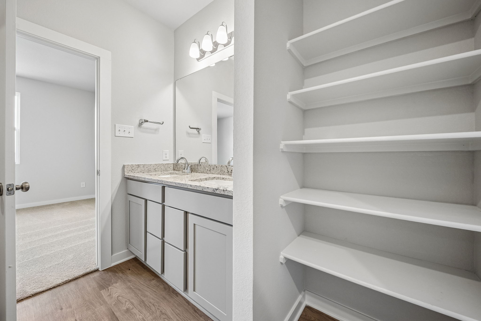 A bathroom with white cabinets.