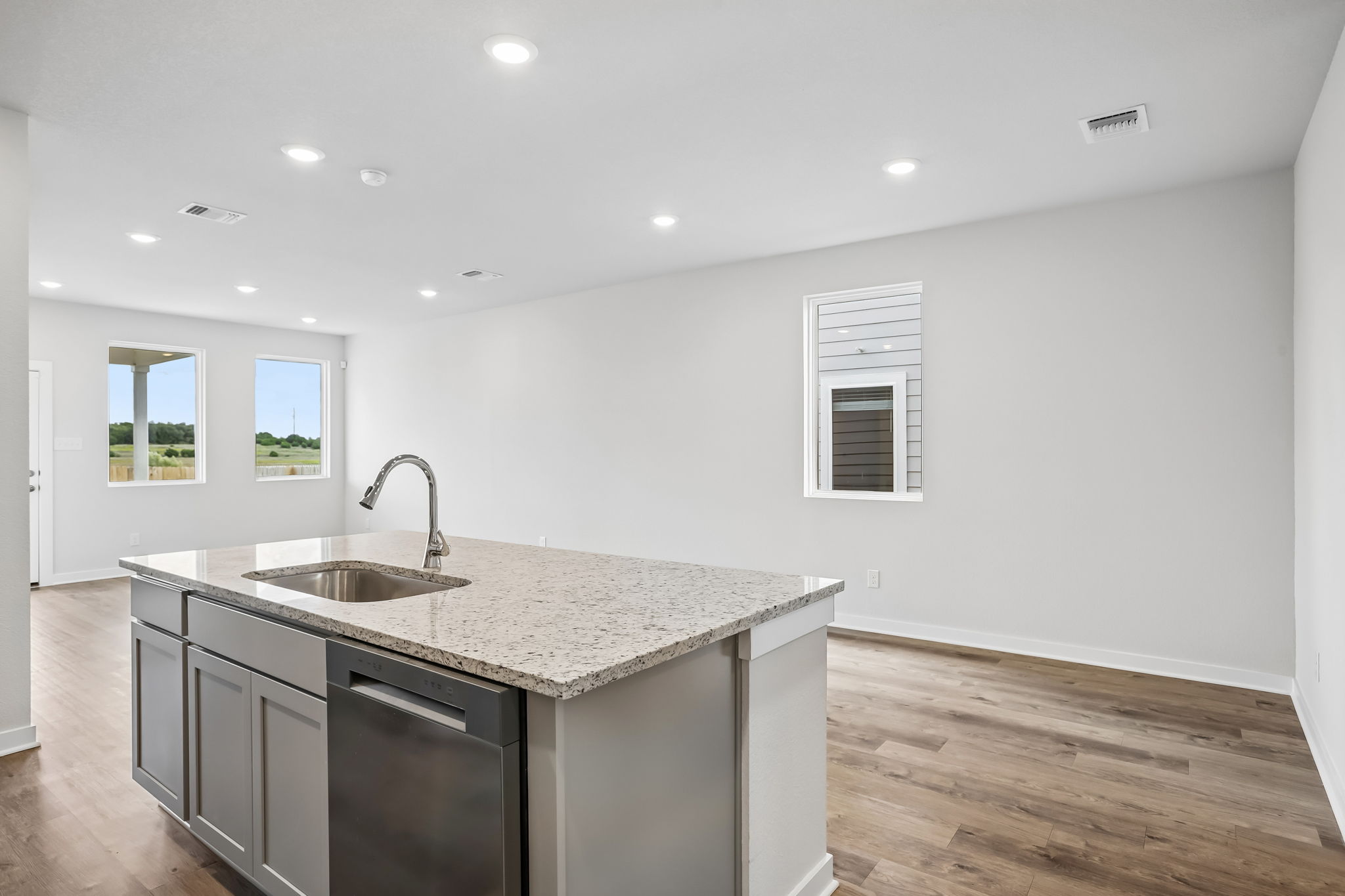A kitchen with a marble countertop.