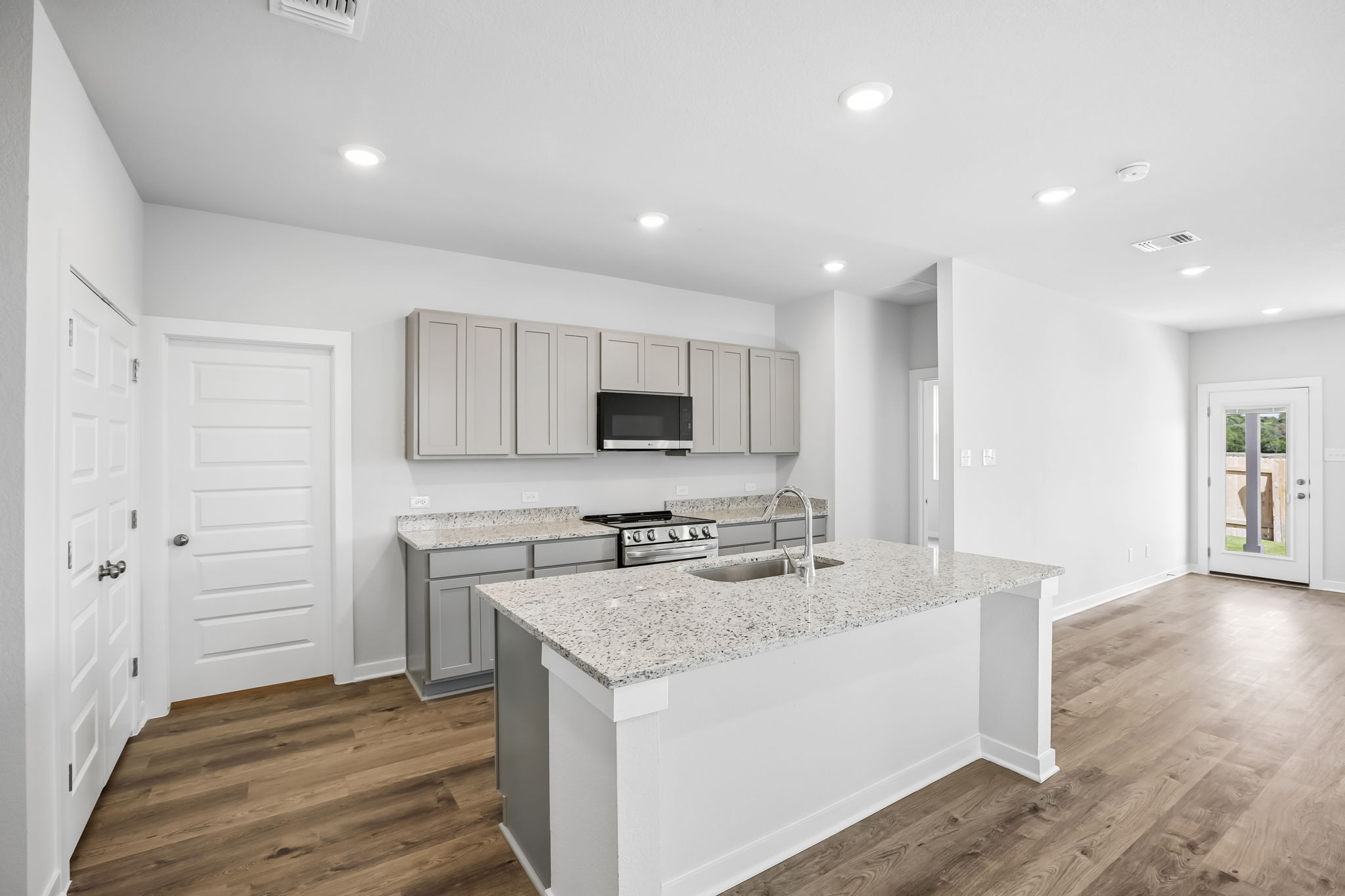 A kitchen with white cabinets.