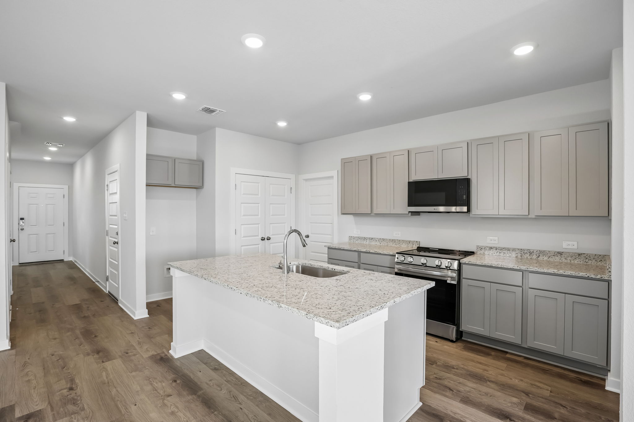 A kitchen with white cabinets.