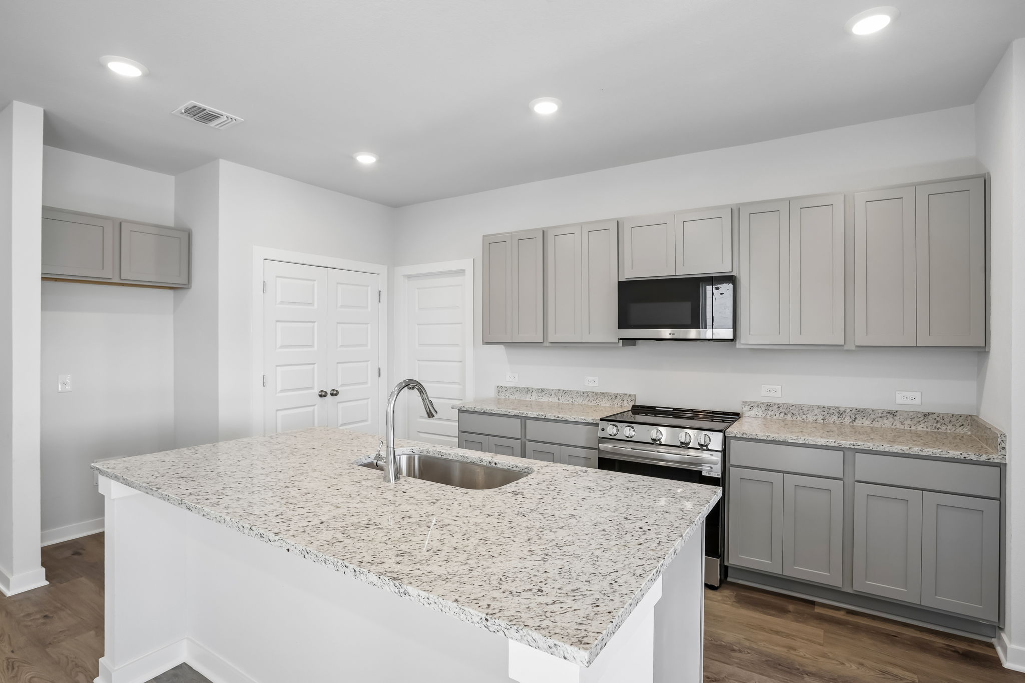 A kitchen with white cabinets.