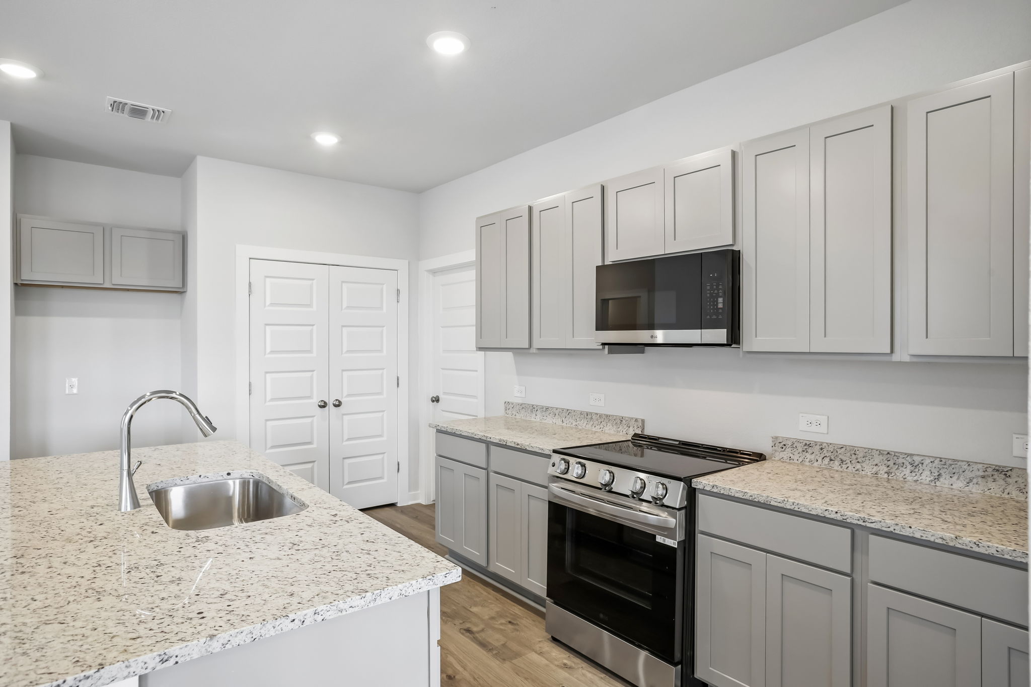 A kitchen with white cabinets.