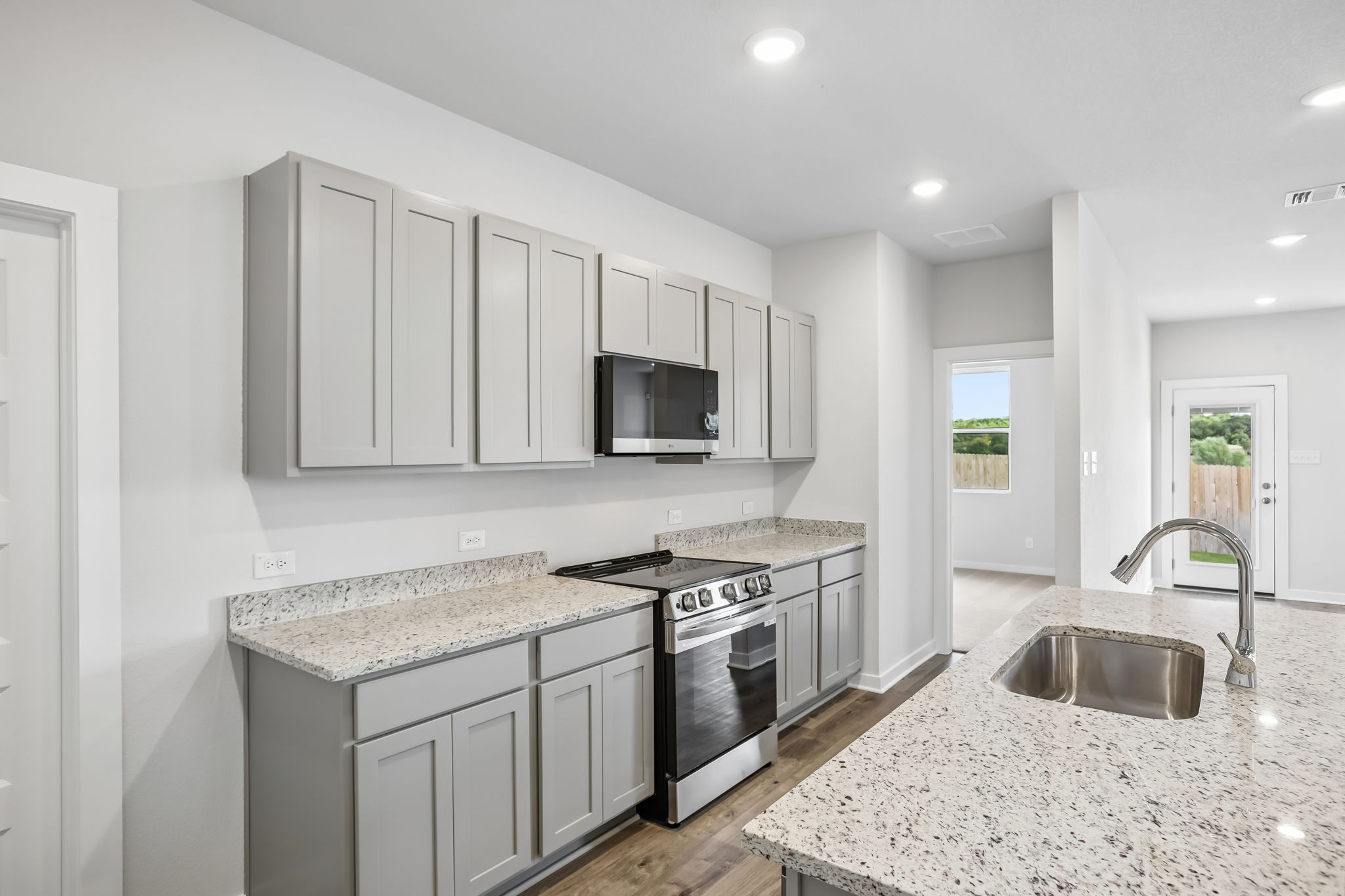 A kitchen with white cabinets.