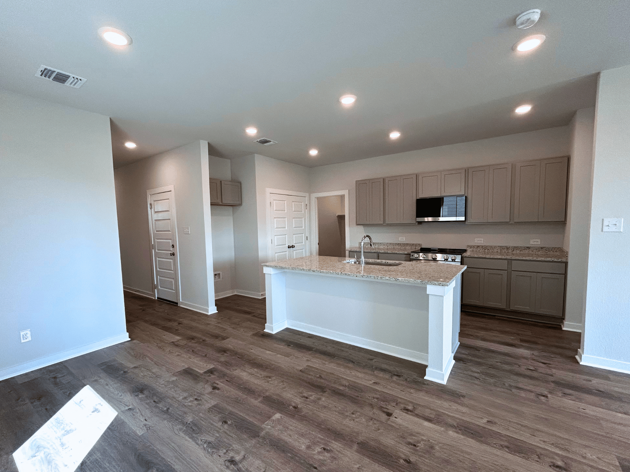 A kitchen with wooden floors.