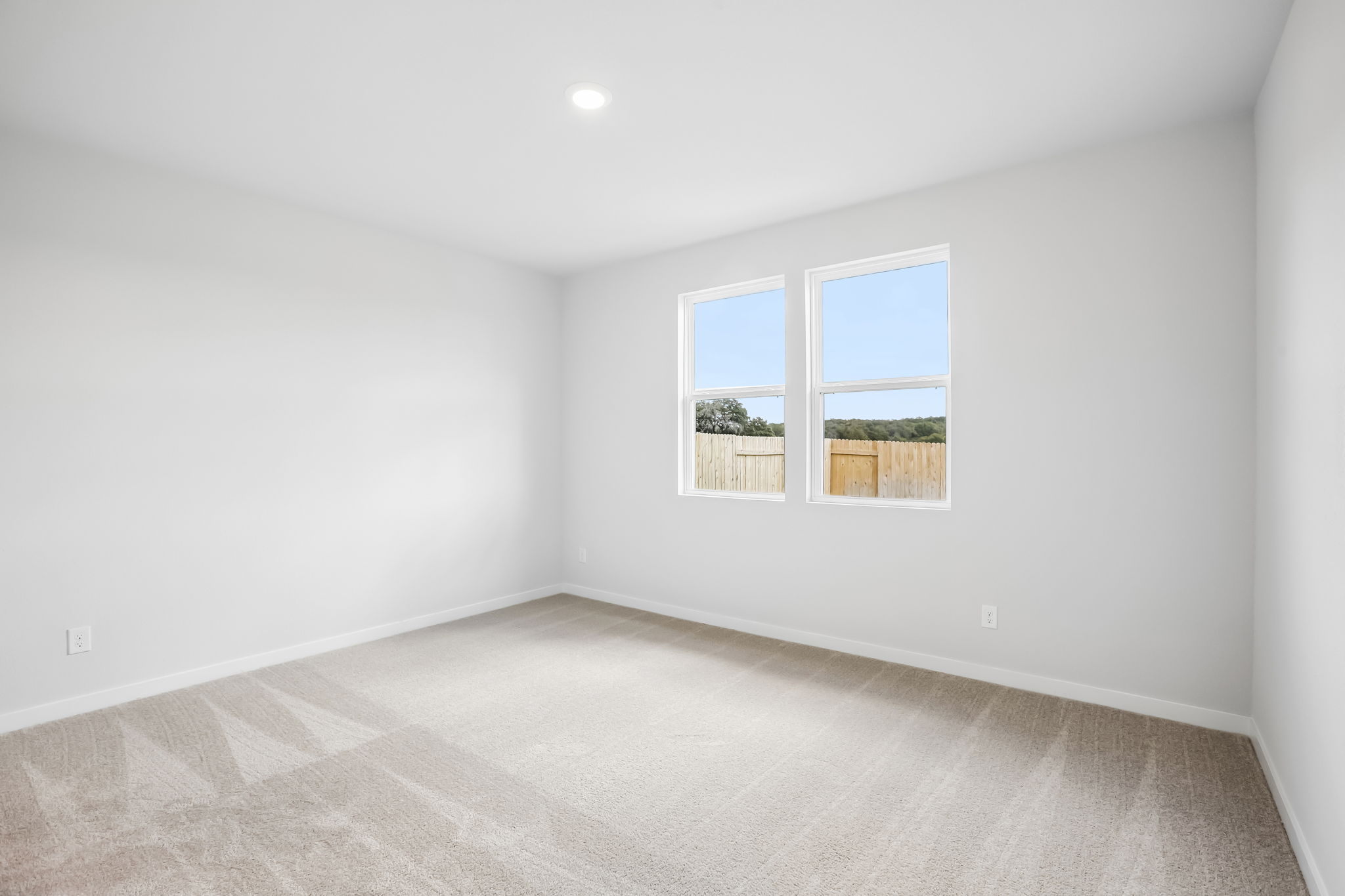 A room with a window and a carpet.
