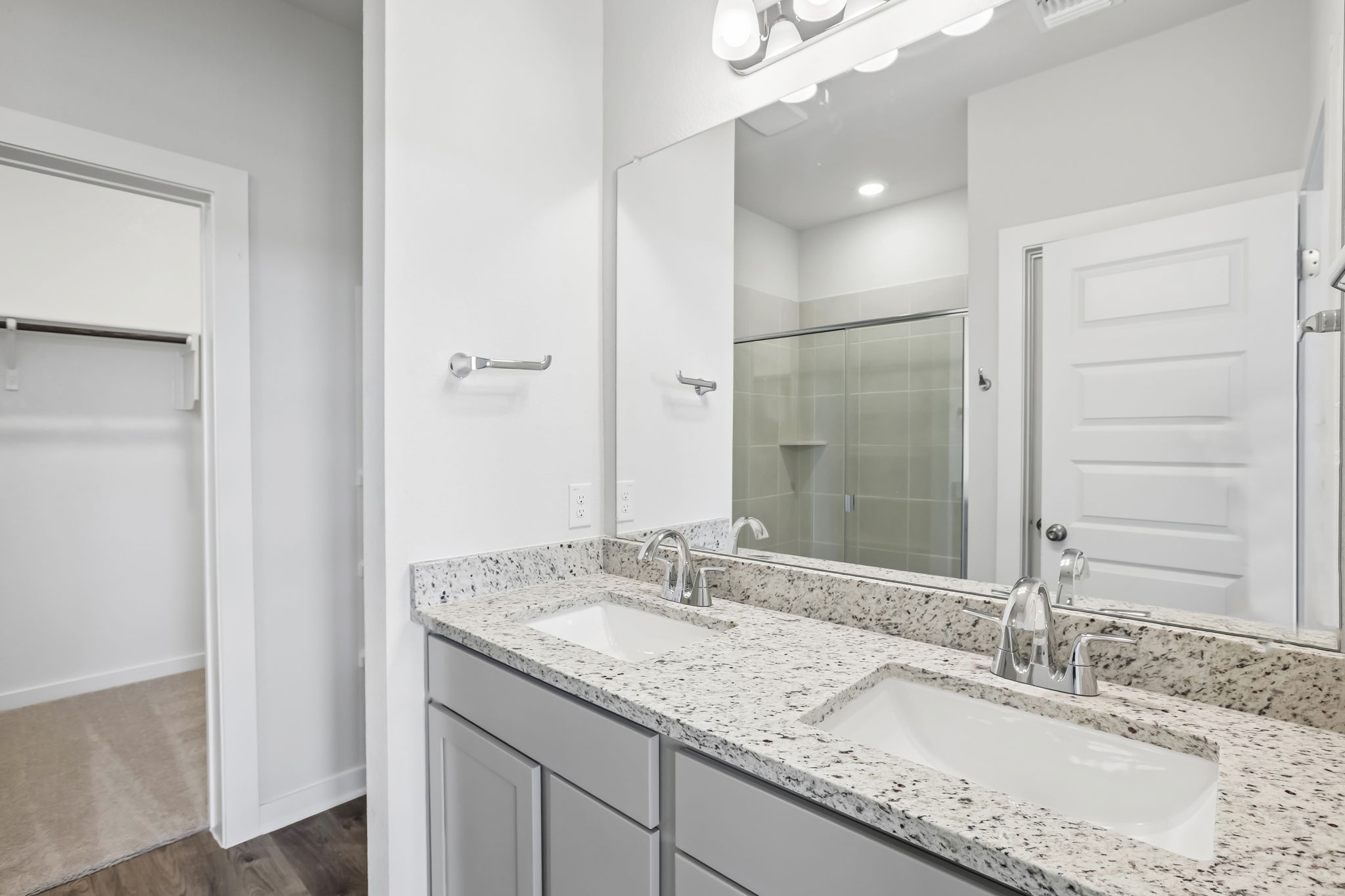A bathroom with a large mirror.
