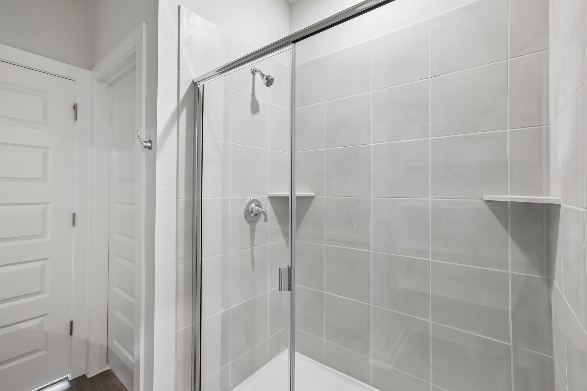 A shower with a glass door.