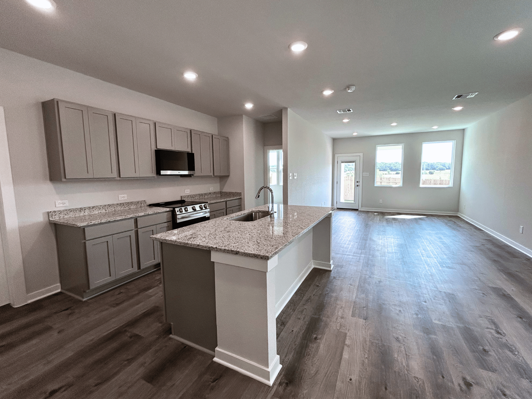A kitchen with wooden floors.