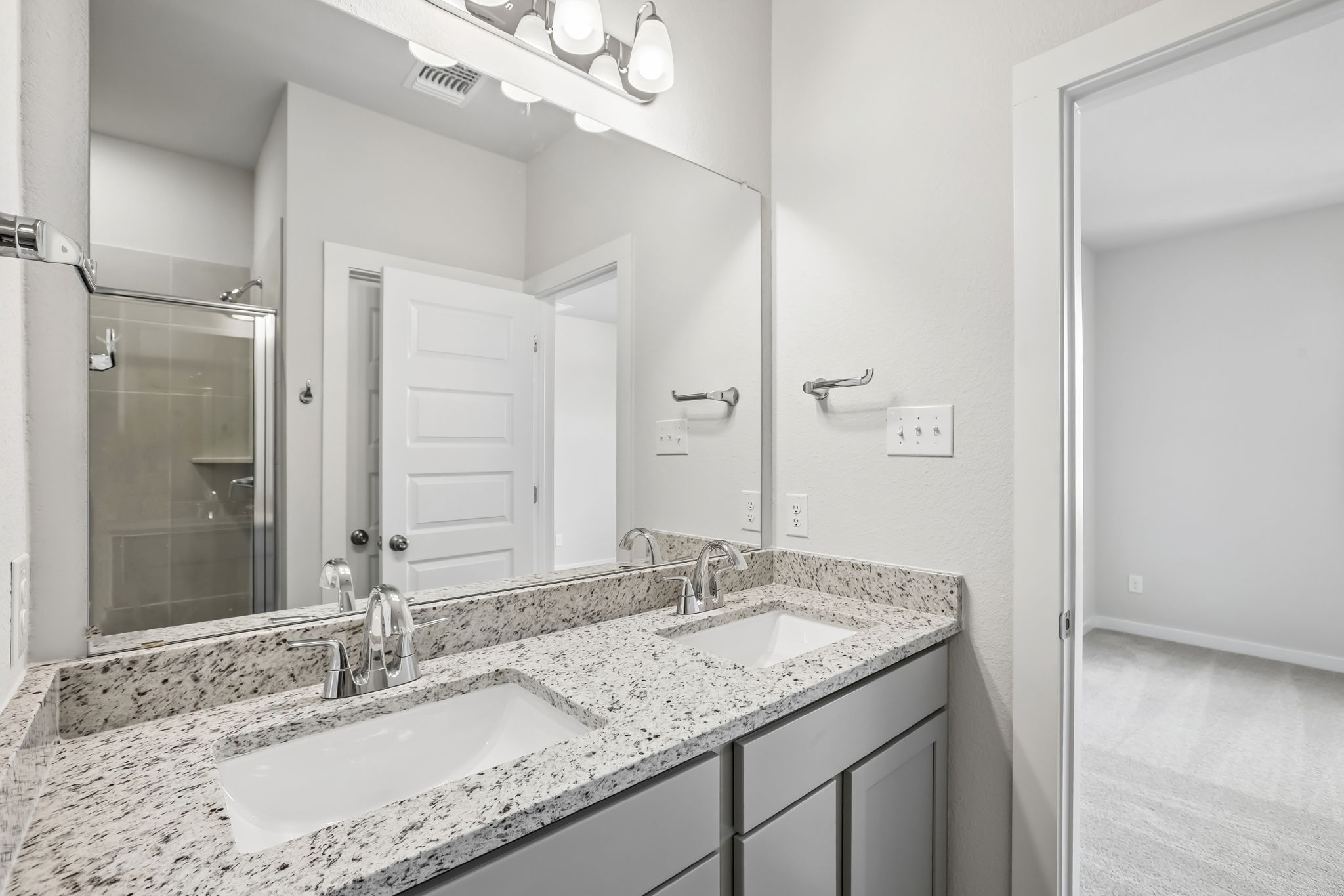 A bathroom with a large mirror.