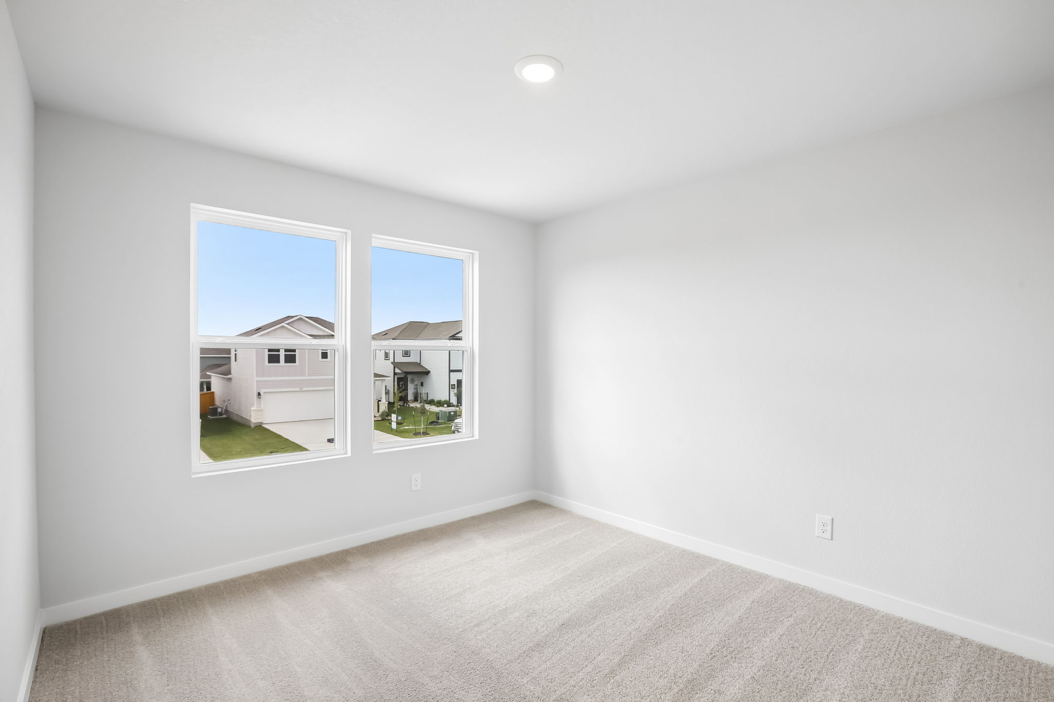 A room with a window and a carpet.