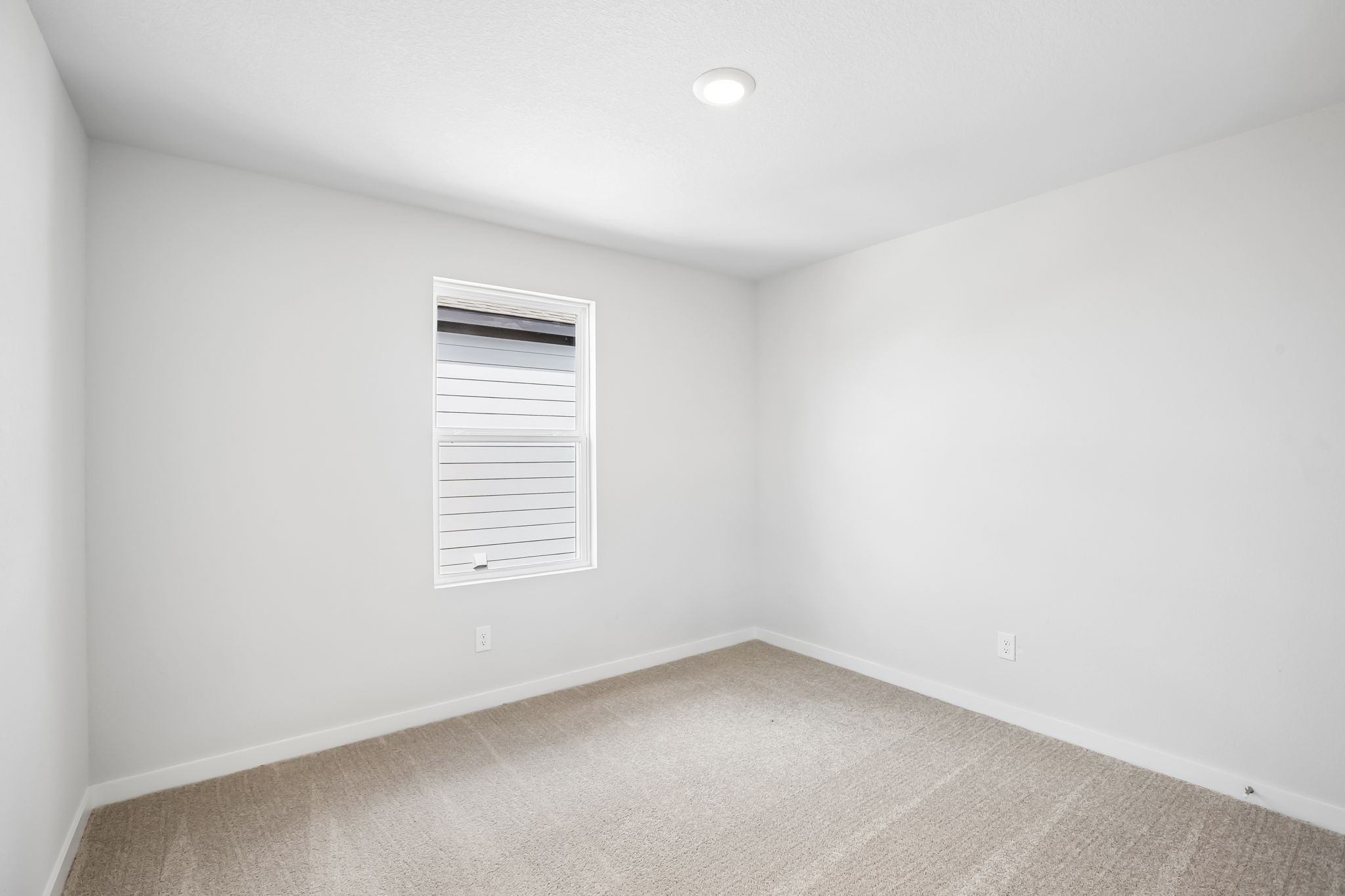 A white room with a vent.