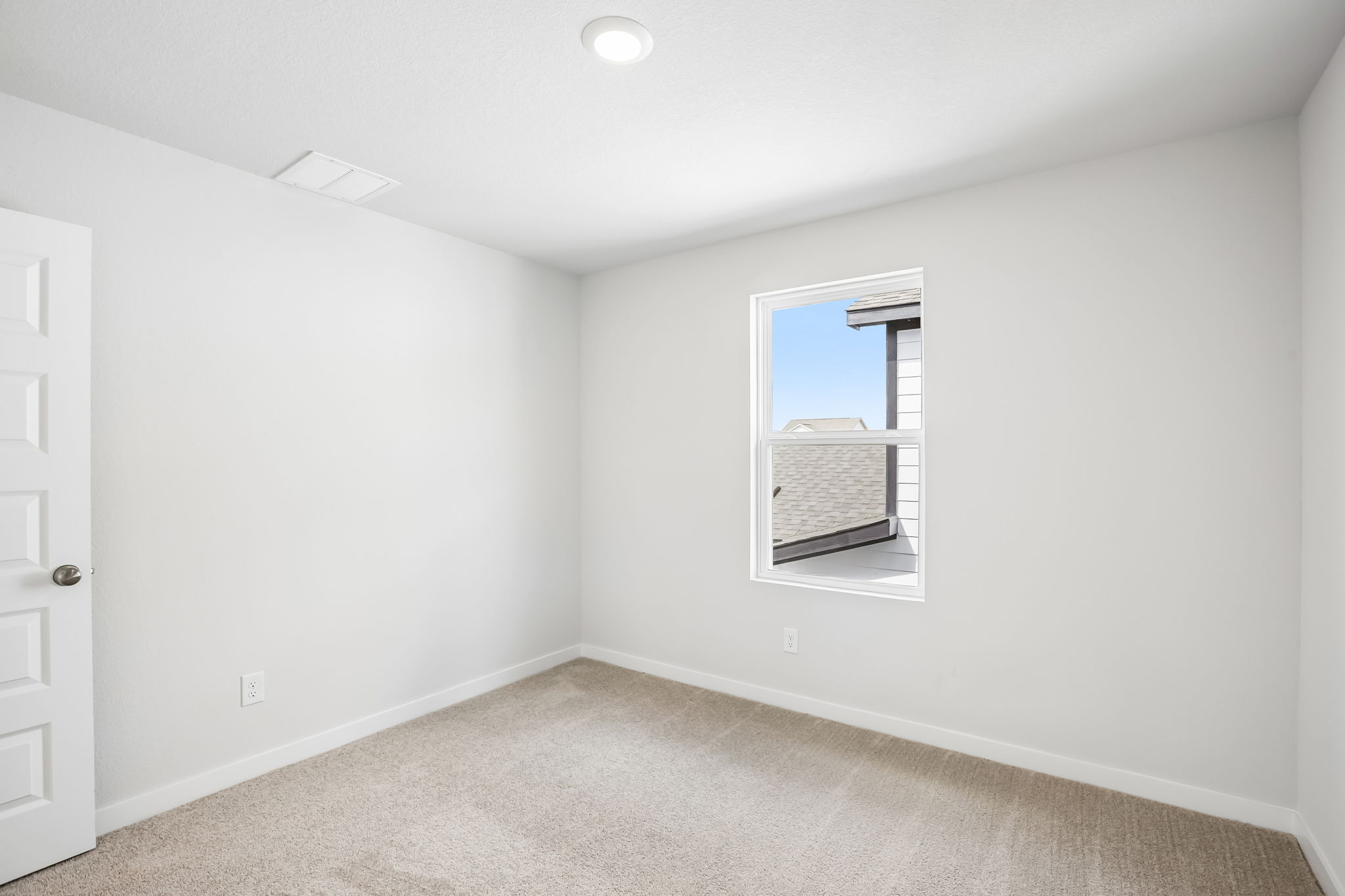 A room with a window and a door.