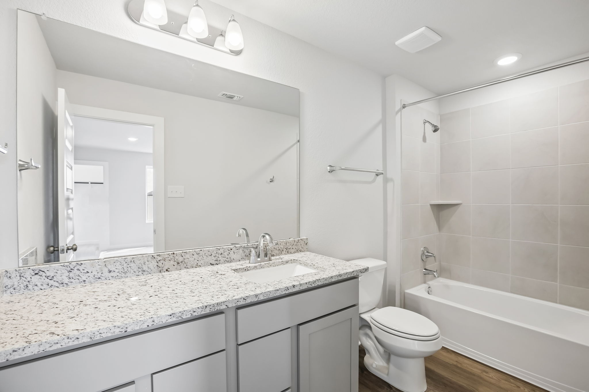 A bathroom with a tub sink and toilet.