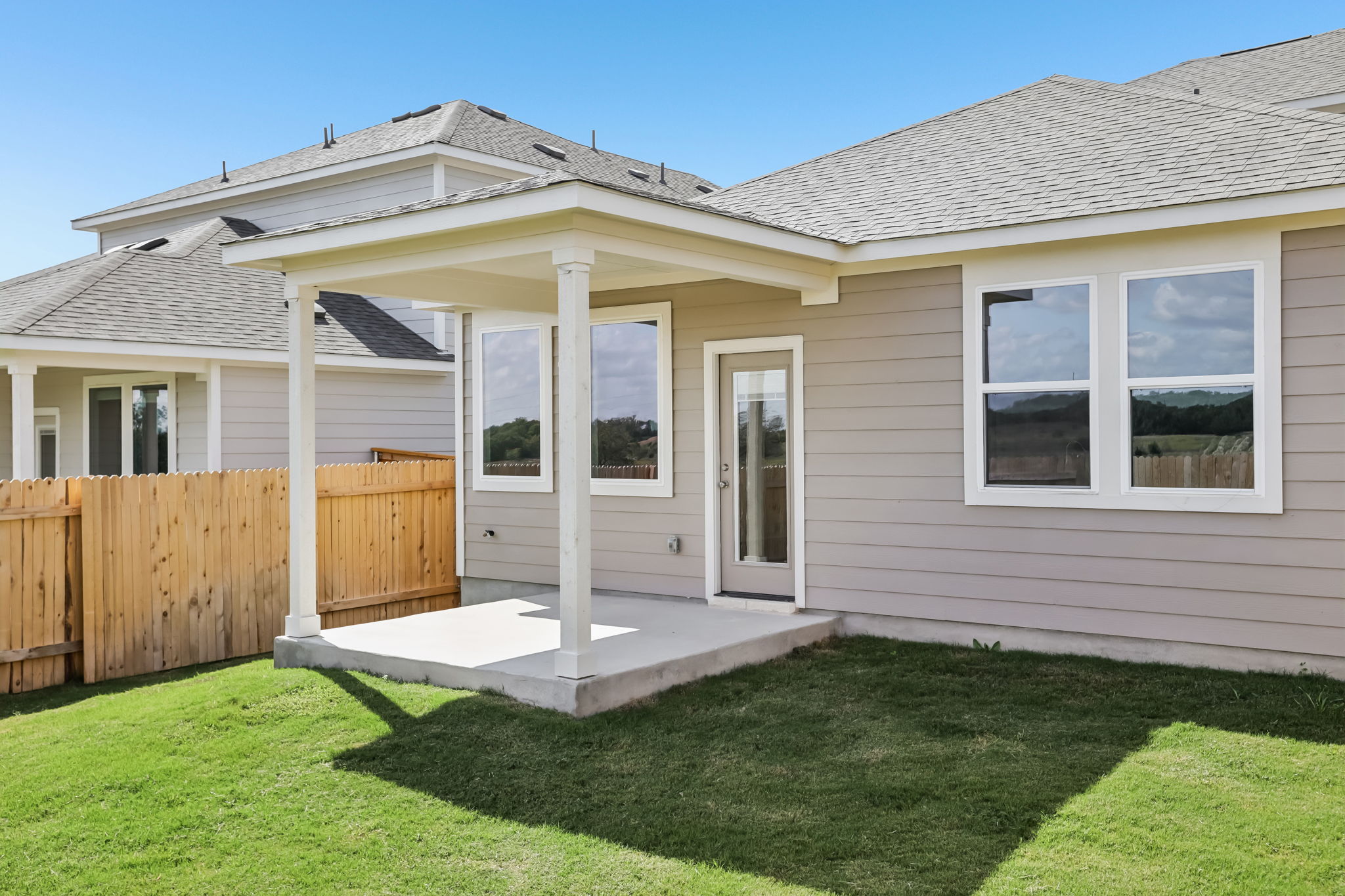 A house with a fence and grass.