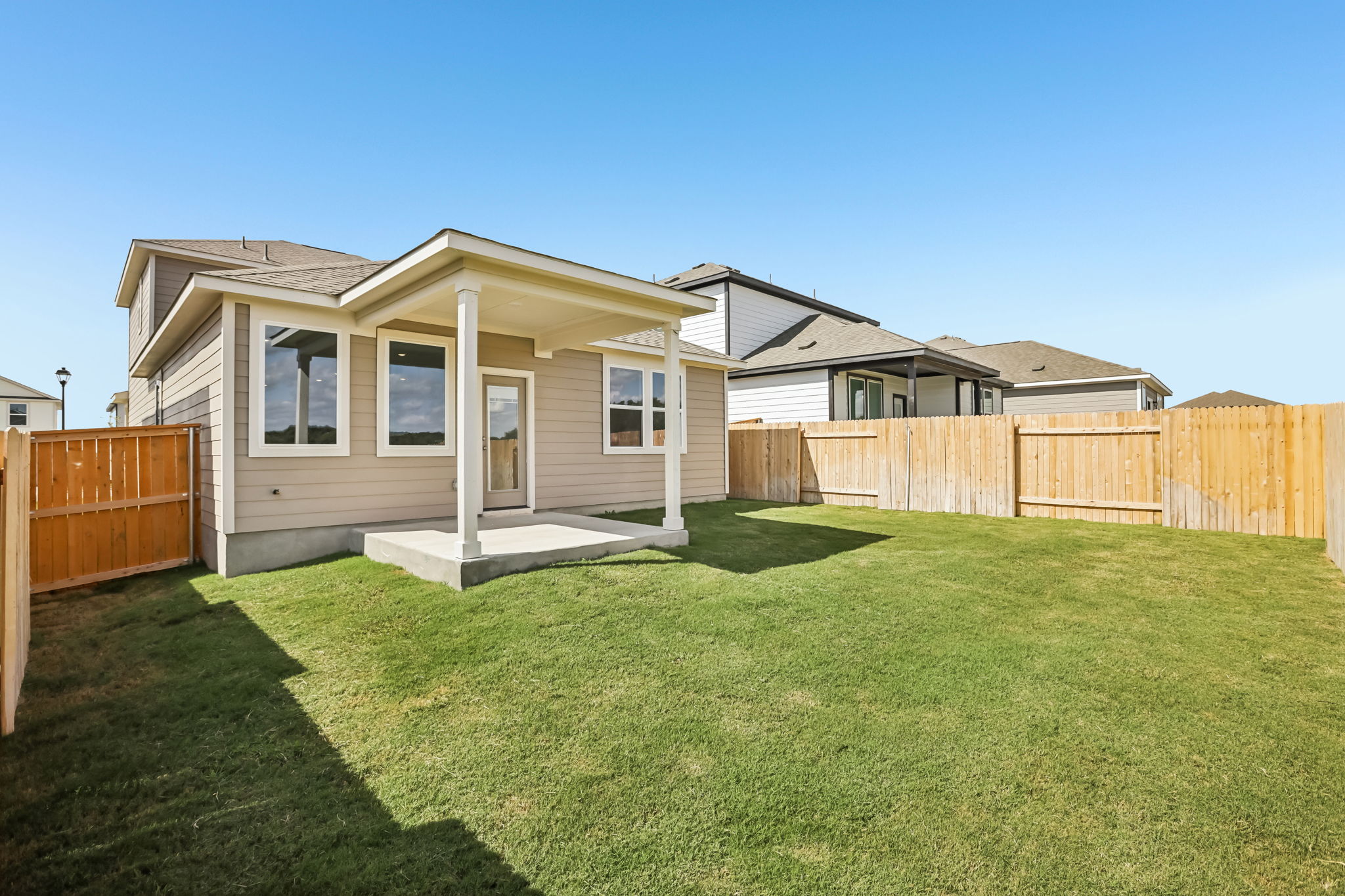 A house with a fence and grass.