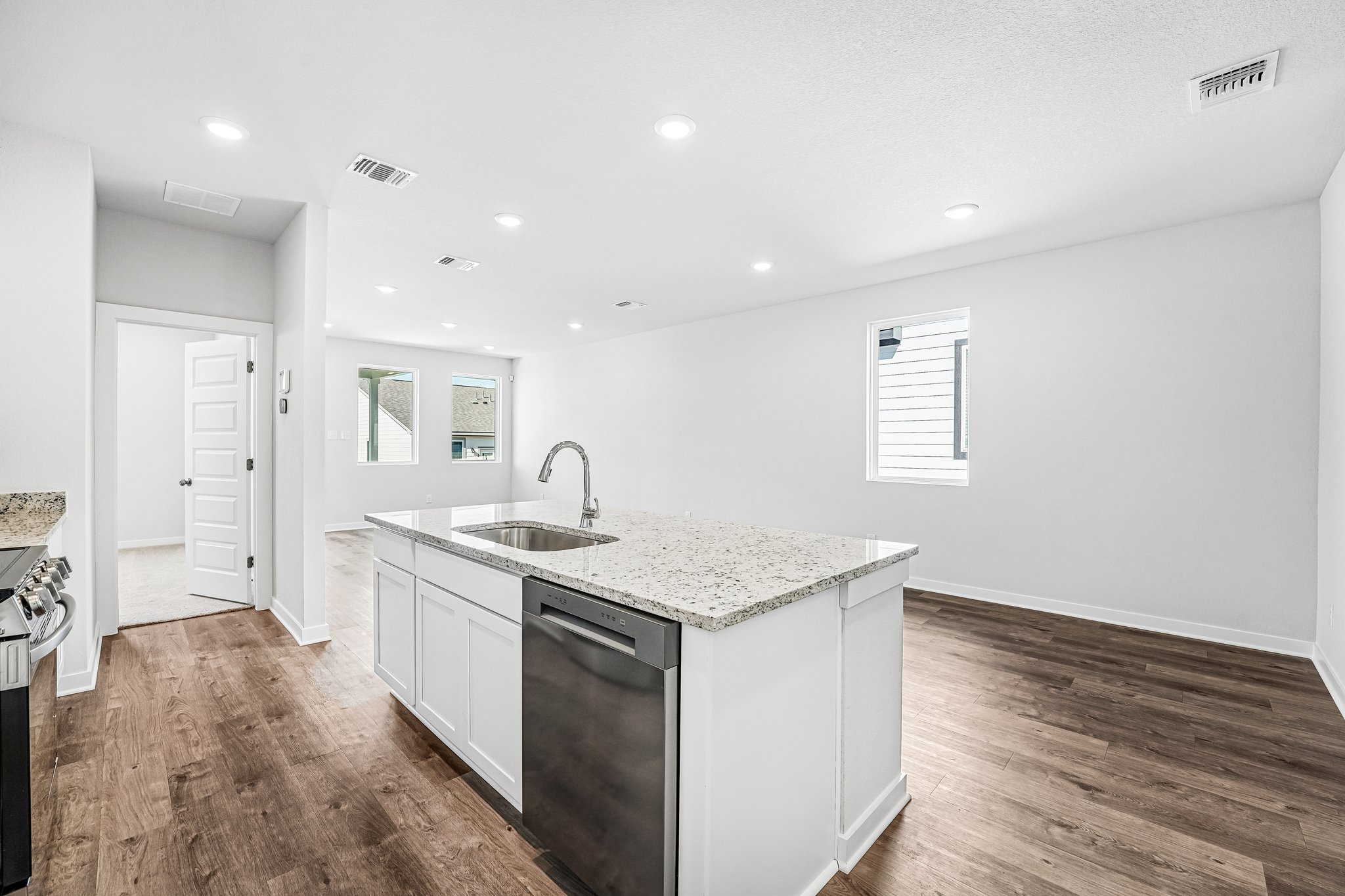 A kitchen with white cabinets.