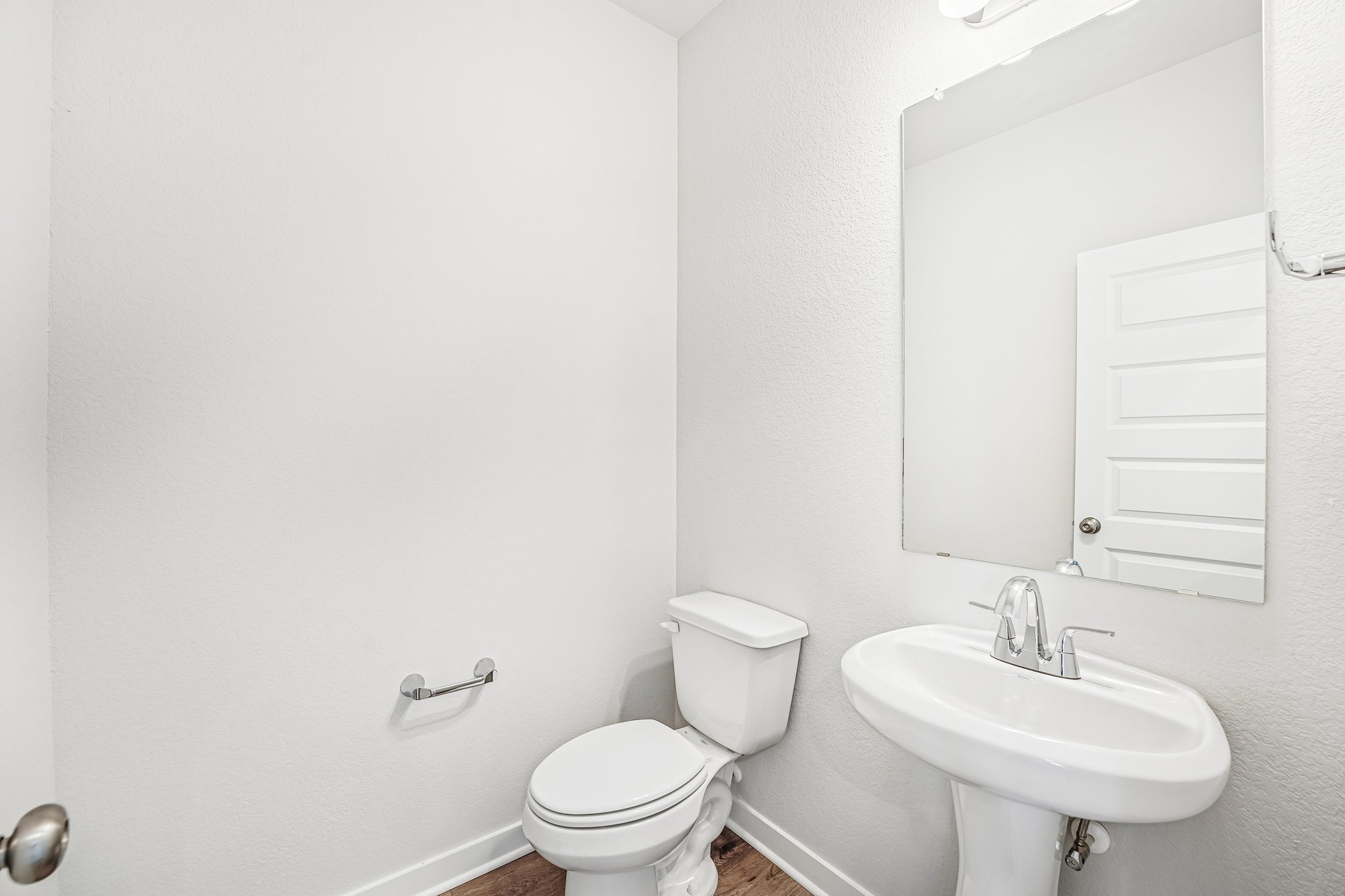 A bathroom with a toilet and sink.