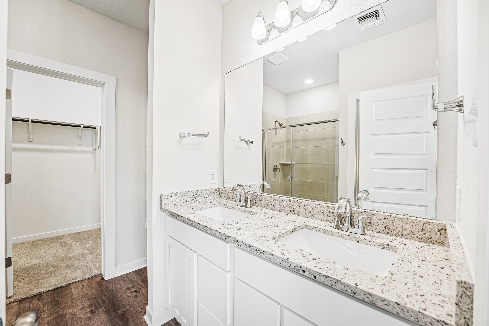 A bathroom with a large mirror.