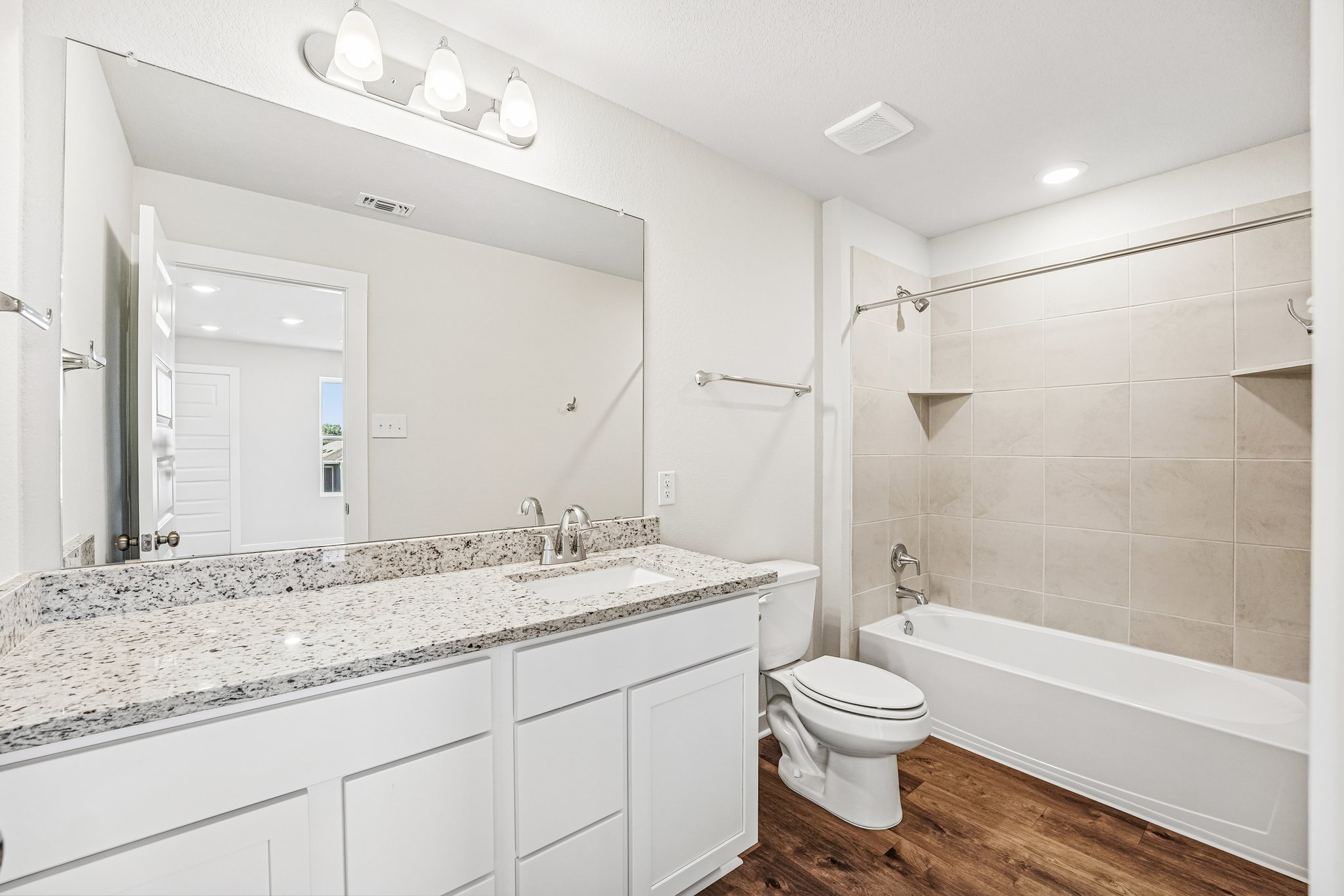 A bathroom with a tub sink and toilet.