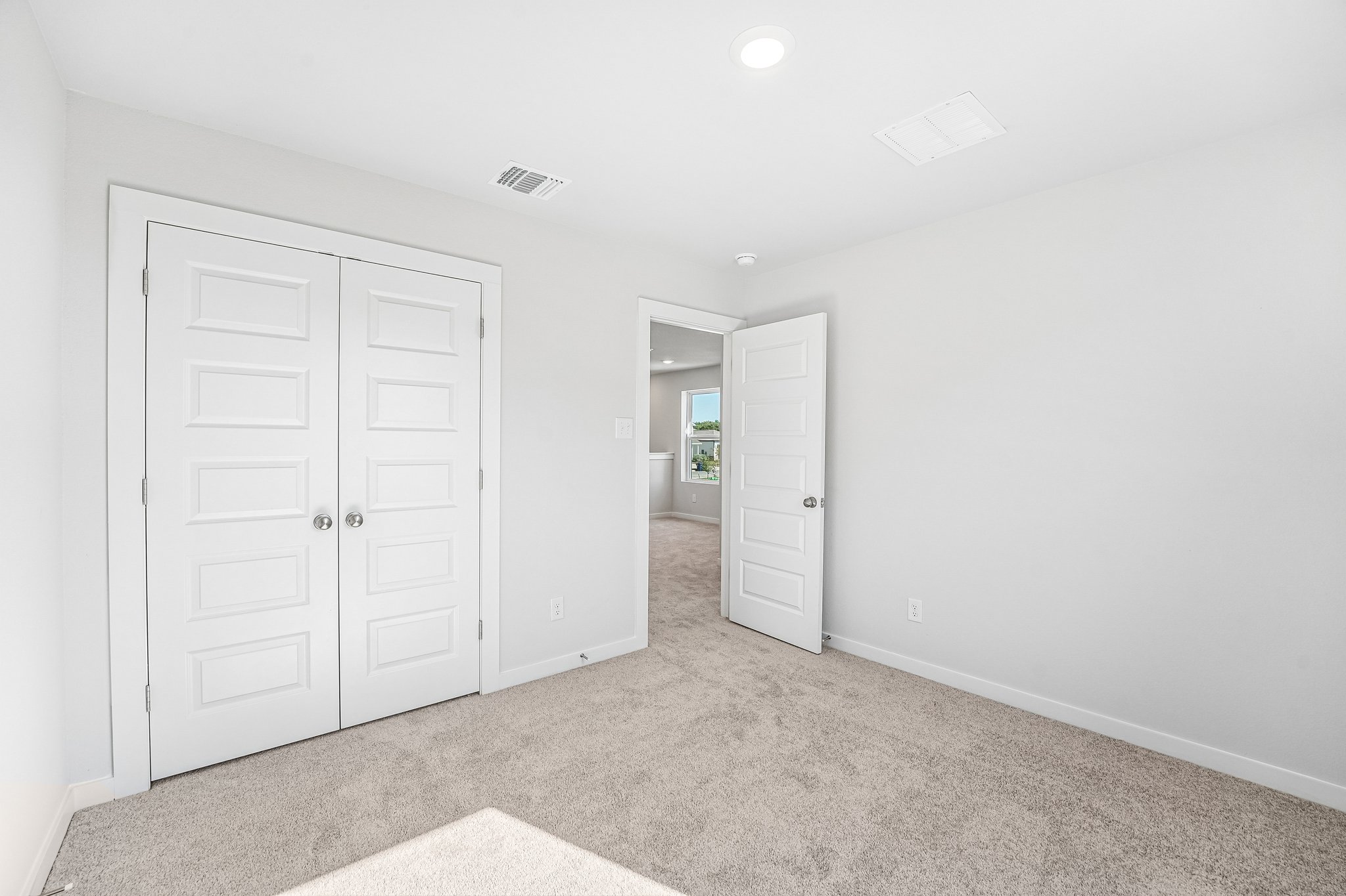 A hallway with white doors.