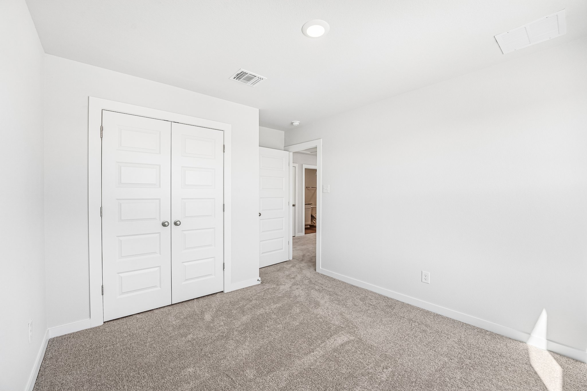 A hallway with white doors.