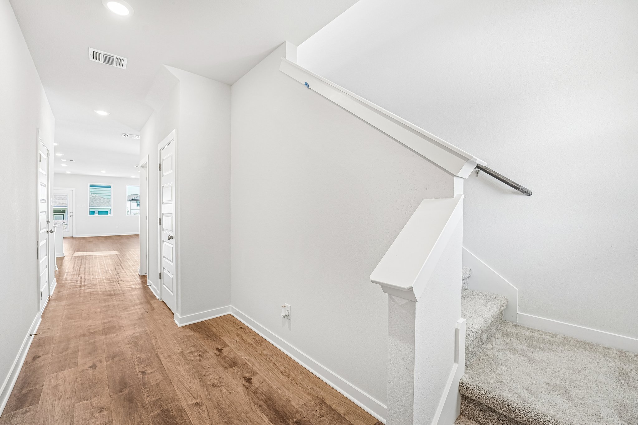 A hallway with white walls.