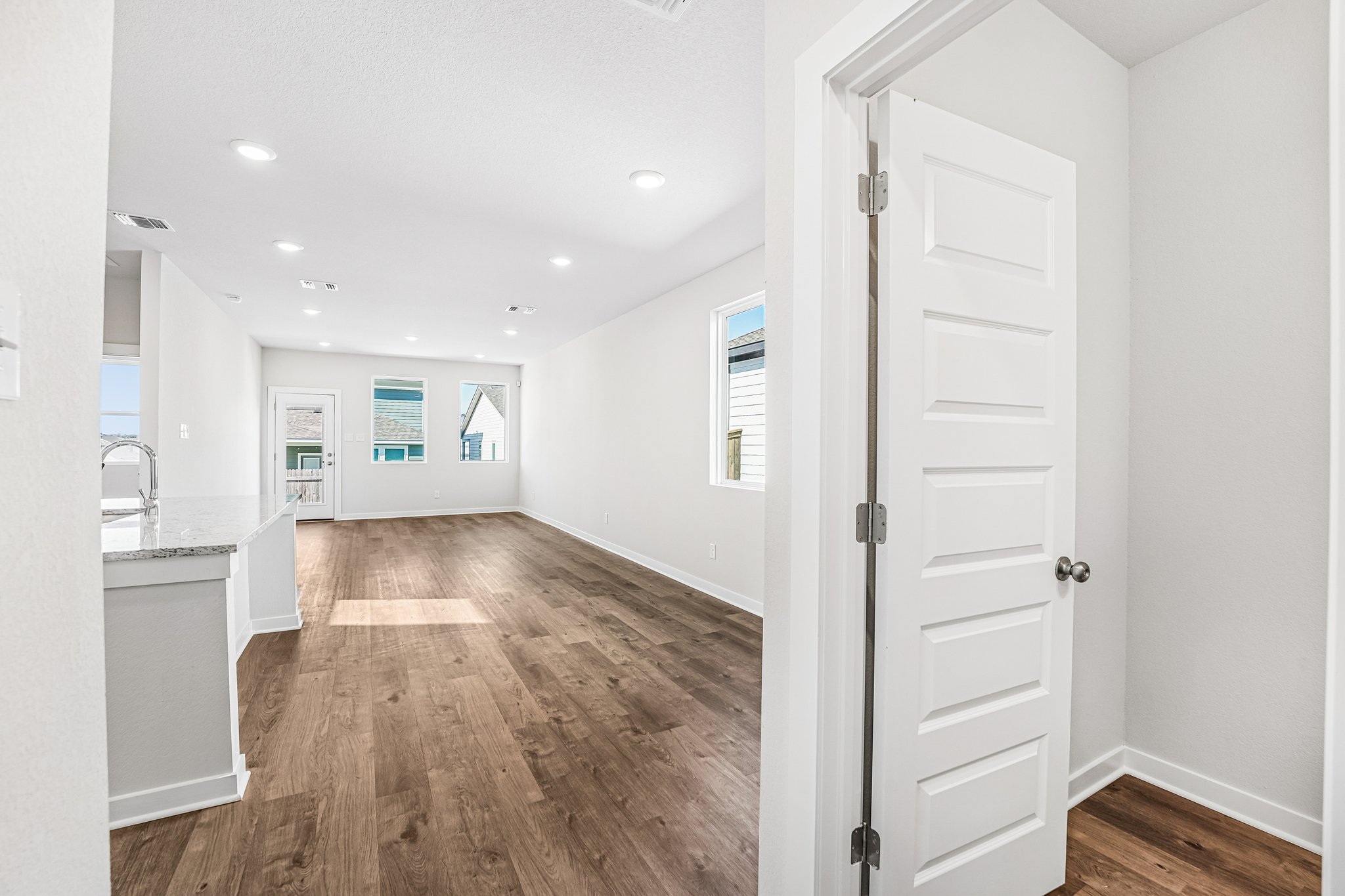 A room with white walls and a wood floor.