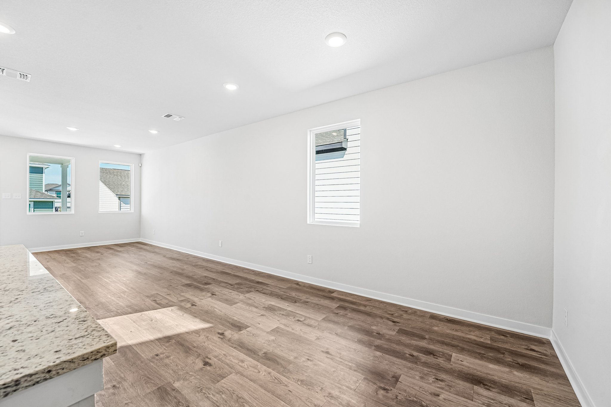 A room with a wood floor and white walls.