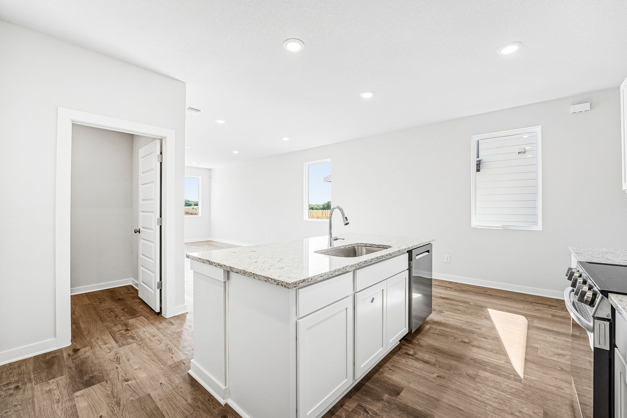 A kitchen with white cabinets.