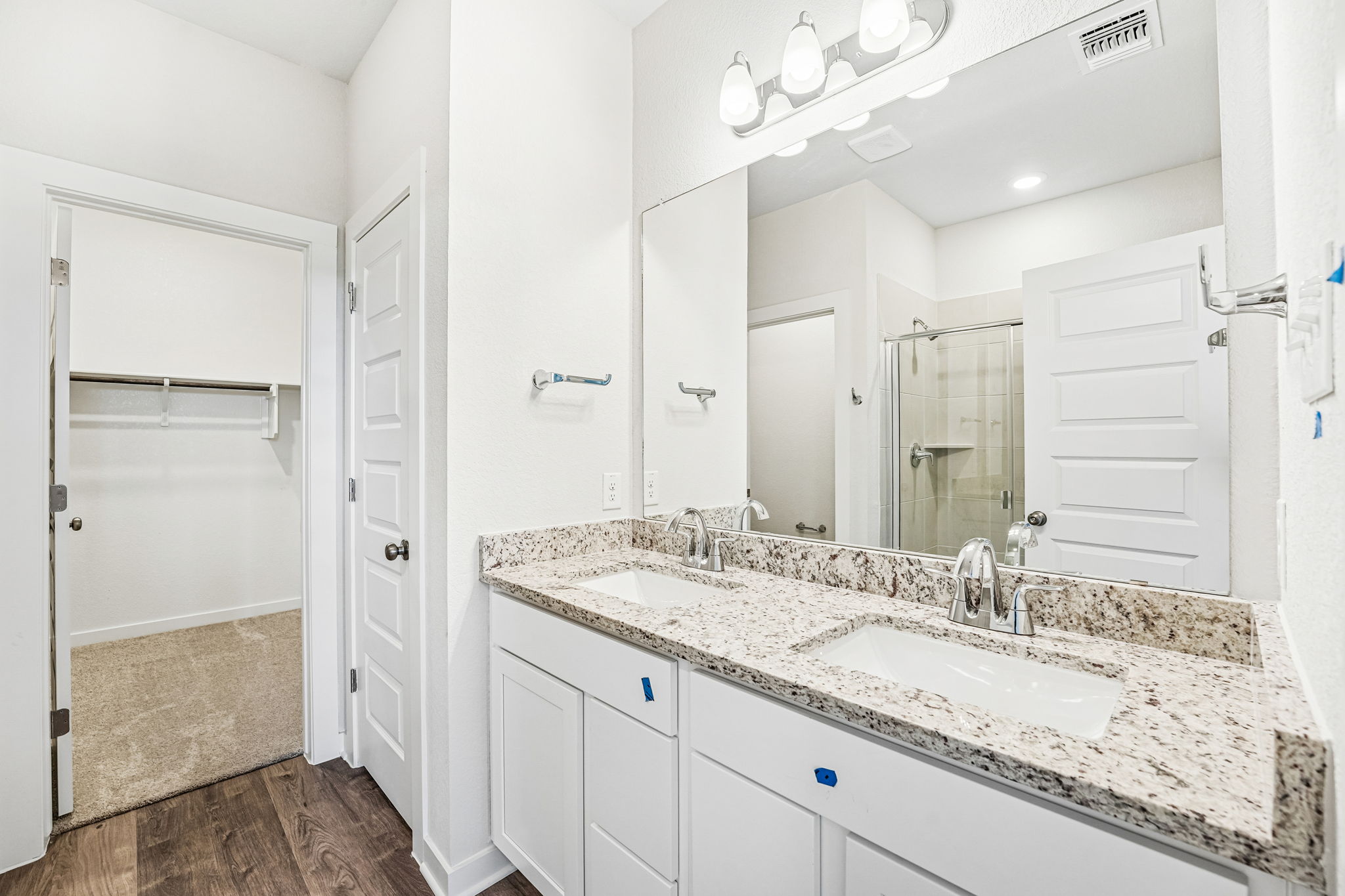 A bathroom with a large mirror.