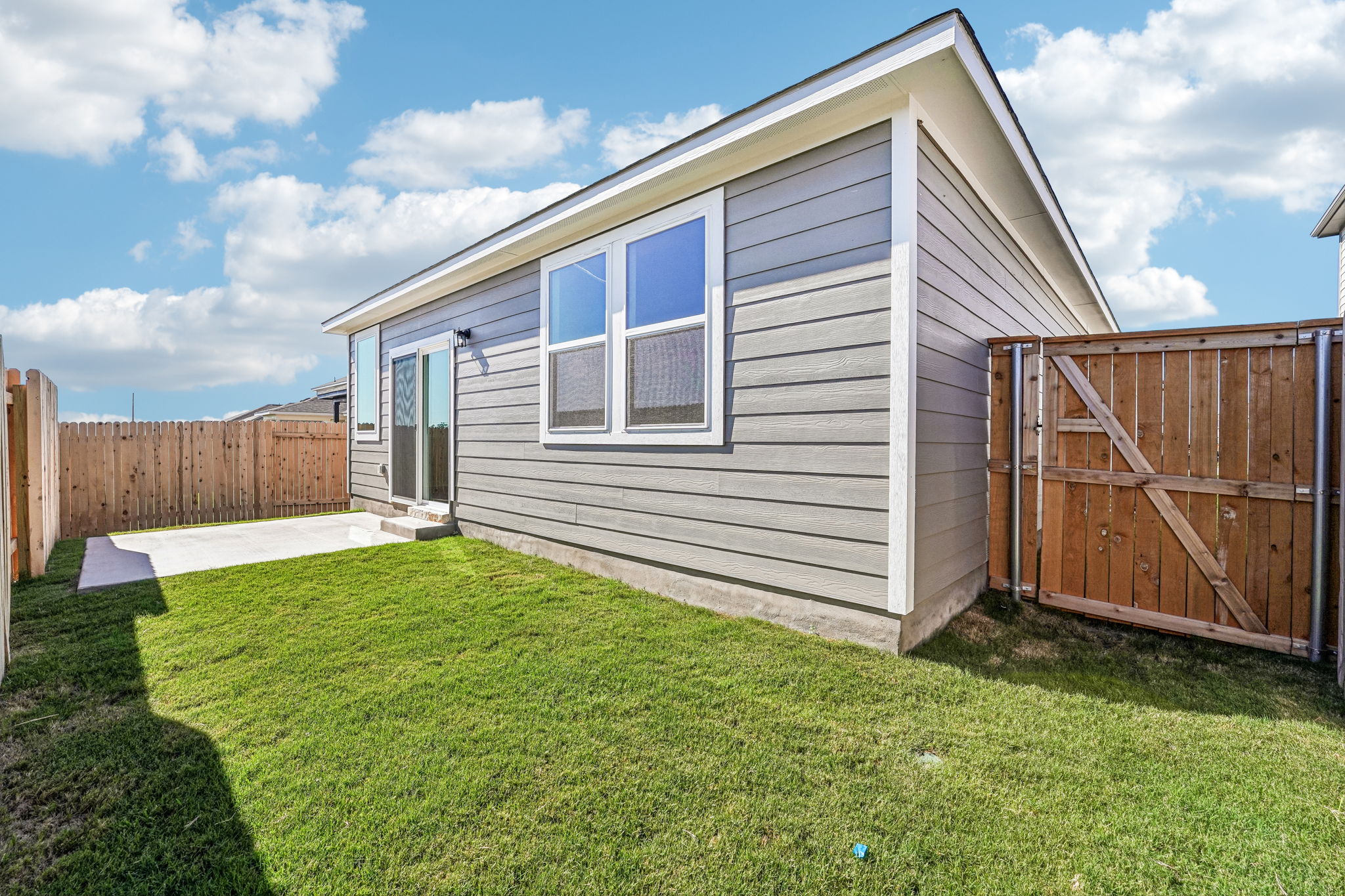 A house with a fence and grass.