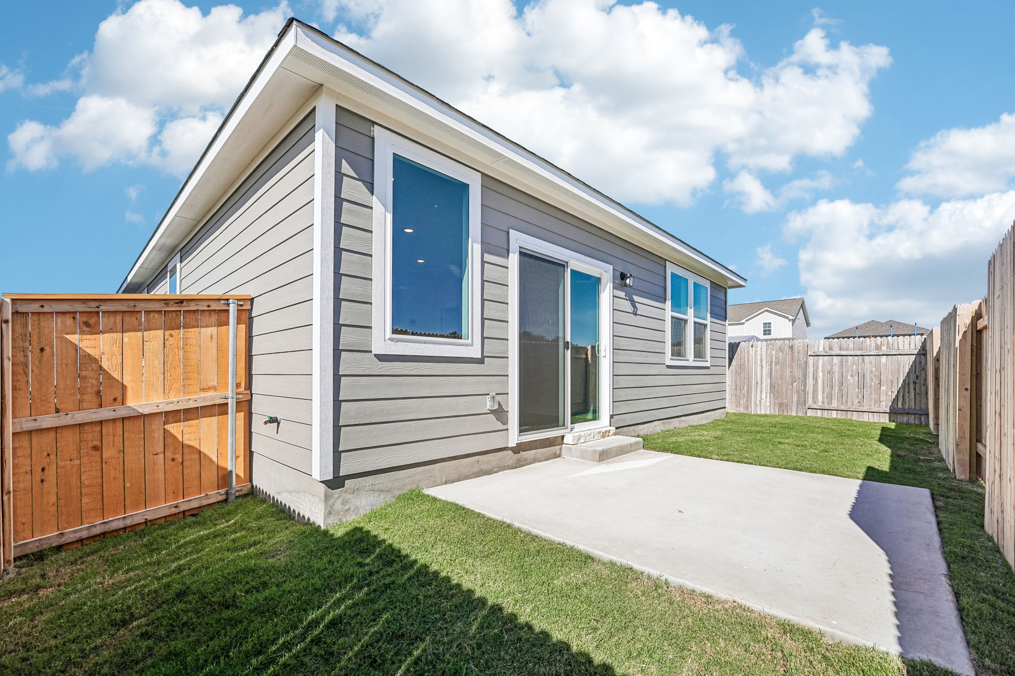 A house with a fence and grass.