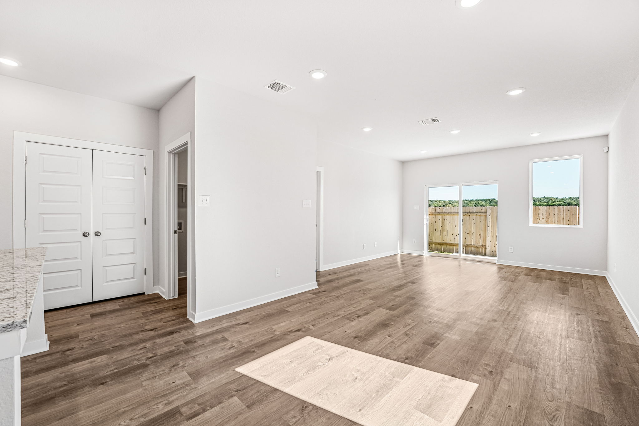 A large empty room with white cabinets.