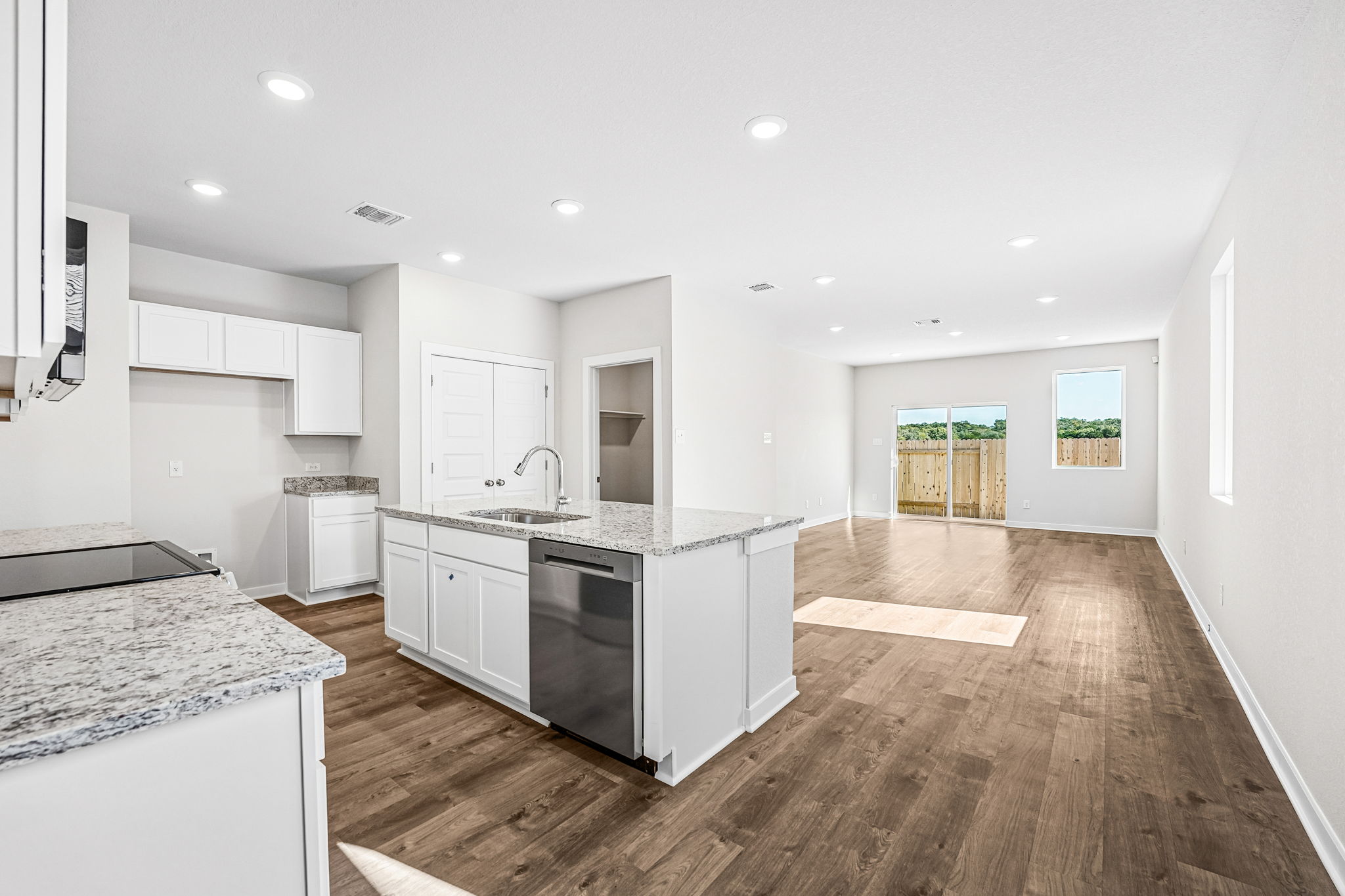 A kitchen with white cabinets.