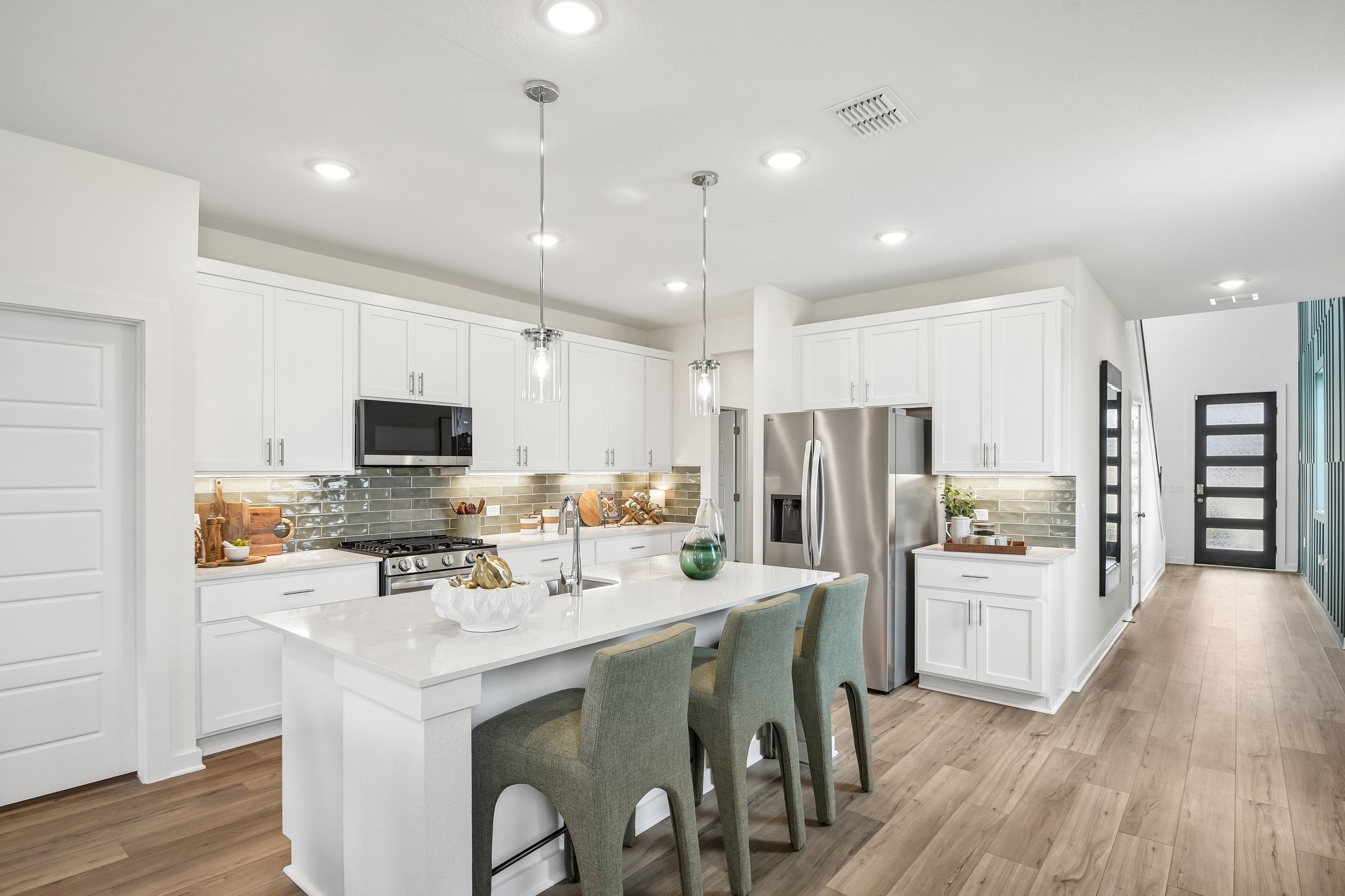 A kitchen with white cabinets.