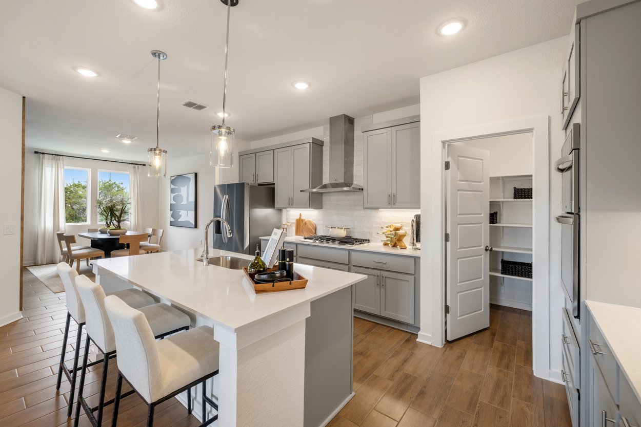 A kitchen with white cabinets.