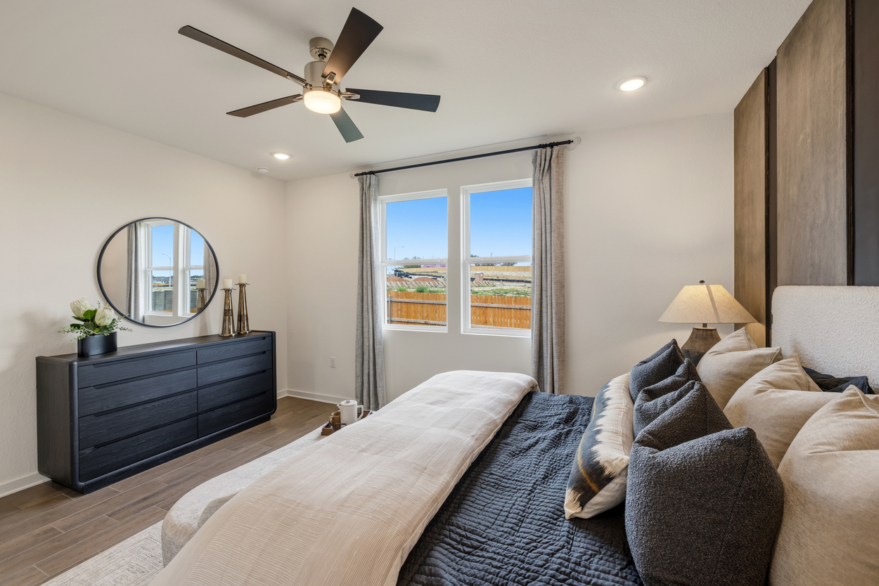 A bedroom with a large window.
