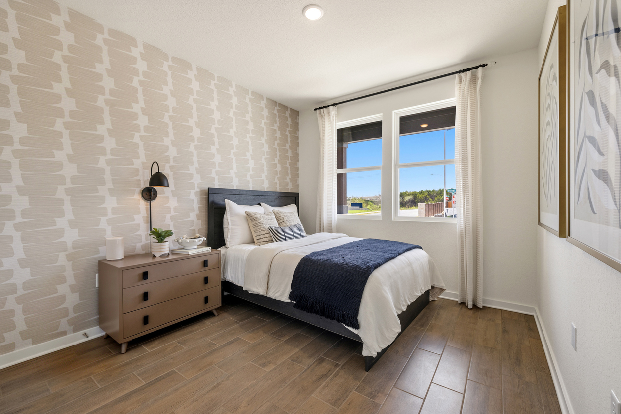 A bedroom with a bed and a dresser.