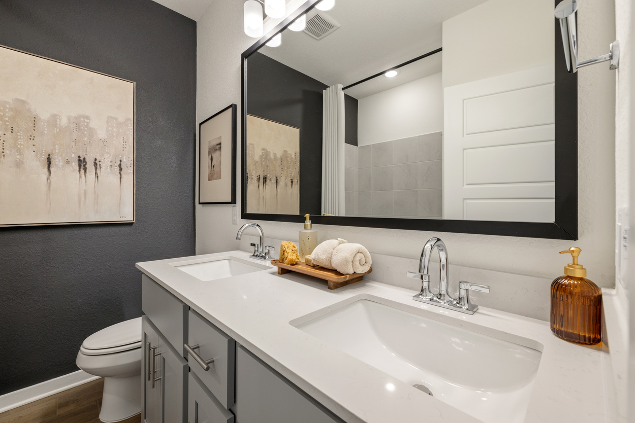 A bathroom with a large mirror.