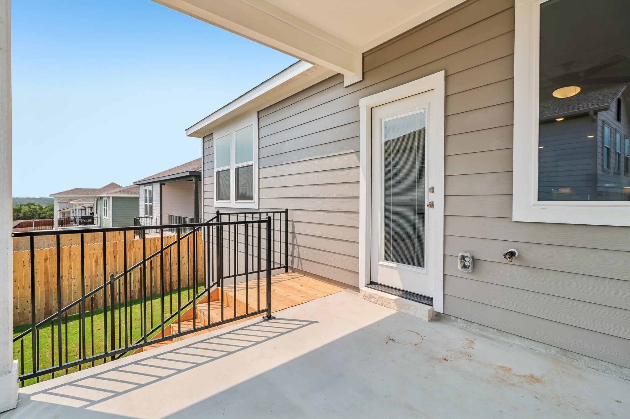A house with a fence and a deck.